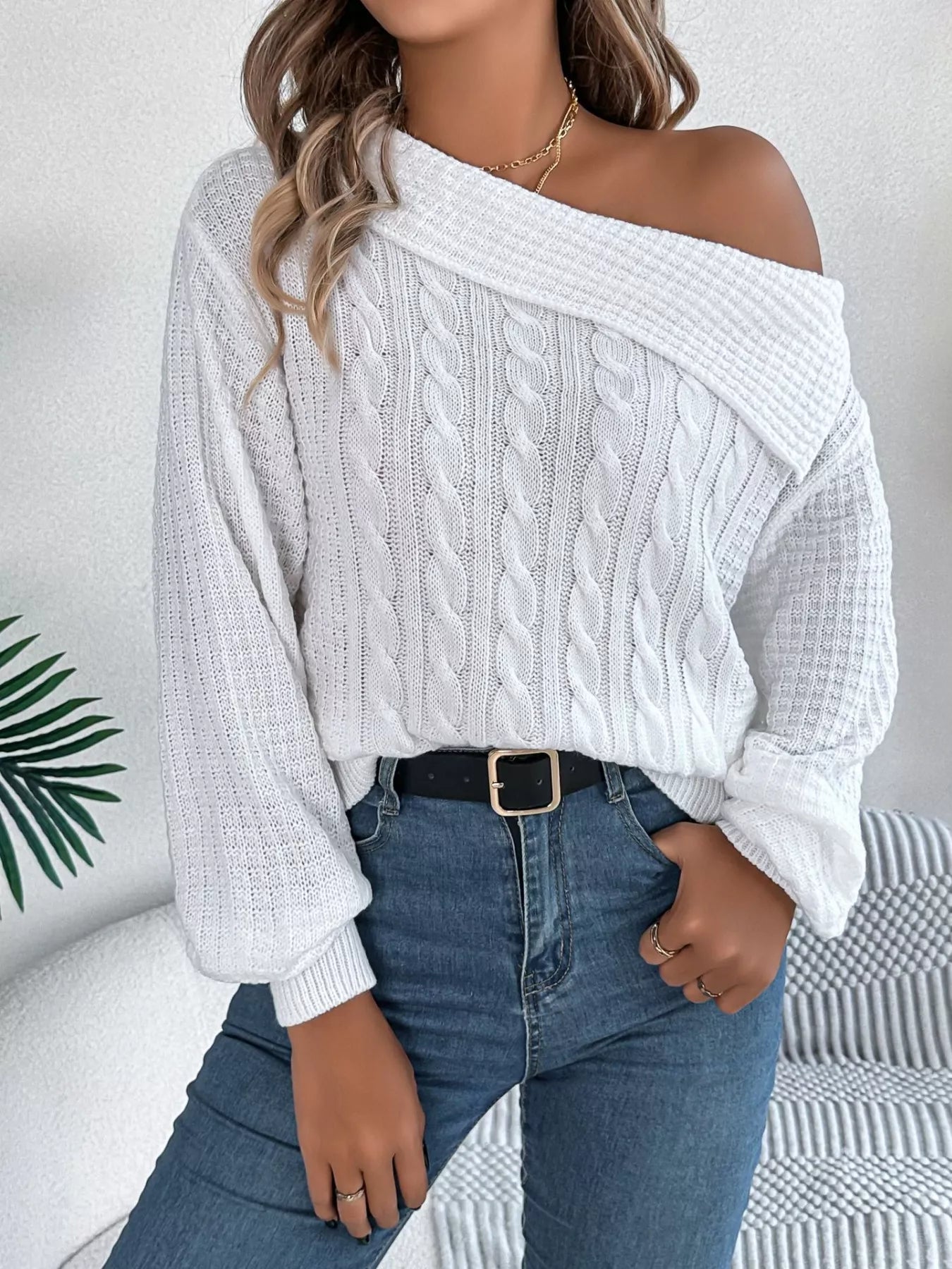 Off-shoulder cable knit sweater in soft acrylic with slight stretch and classic texture.