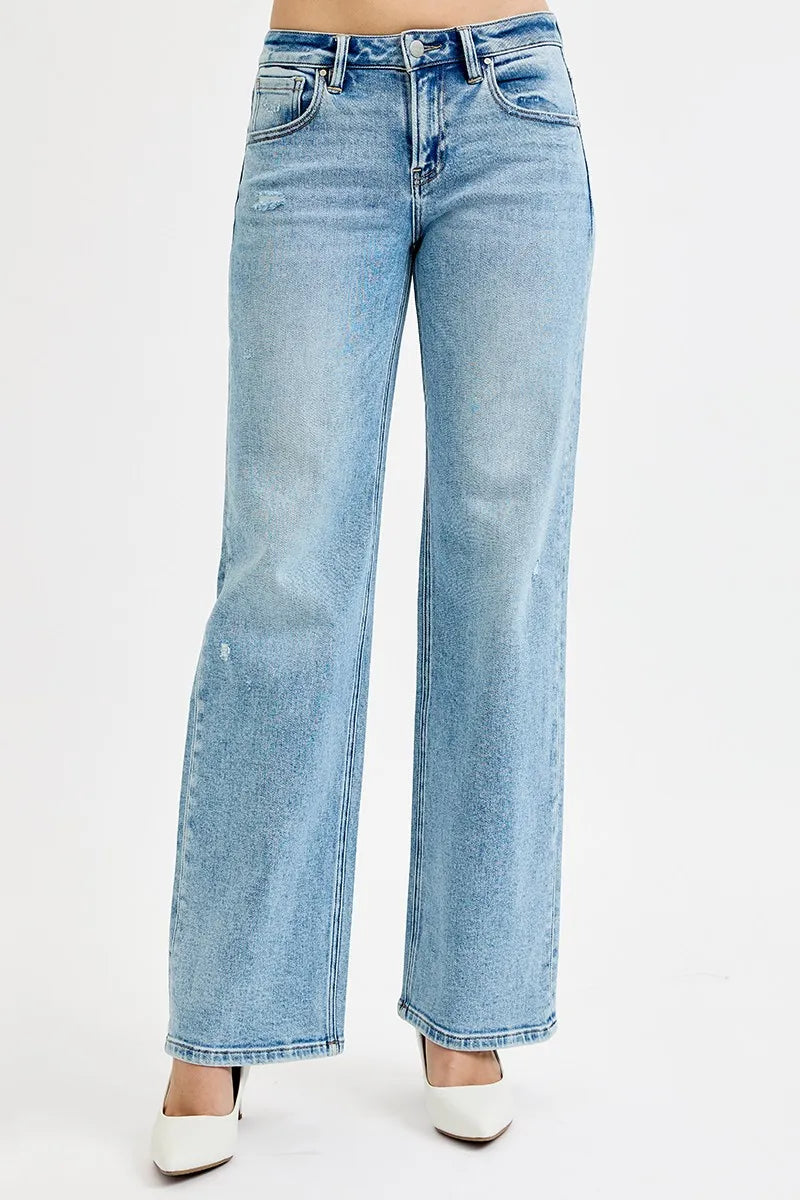 Light wash wide leg flare boyfriend jeans in plus size, shown on model.