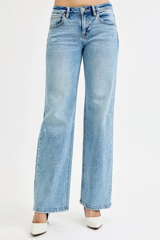 Light wash wide leg flare boyfriend jeans in plus size, shown on model.