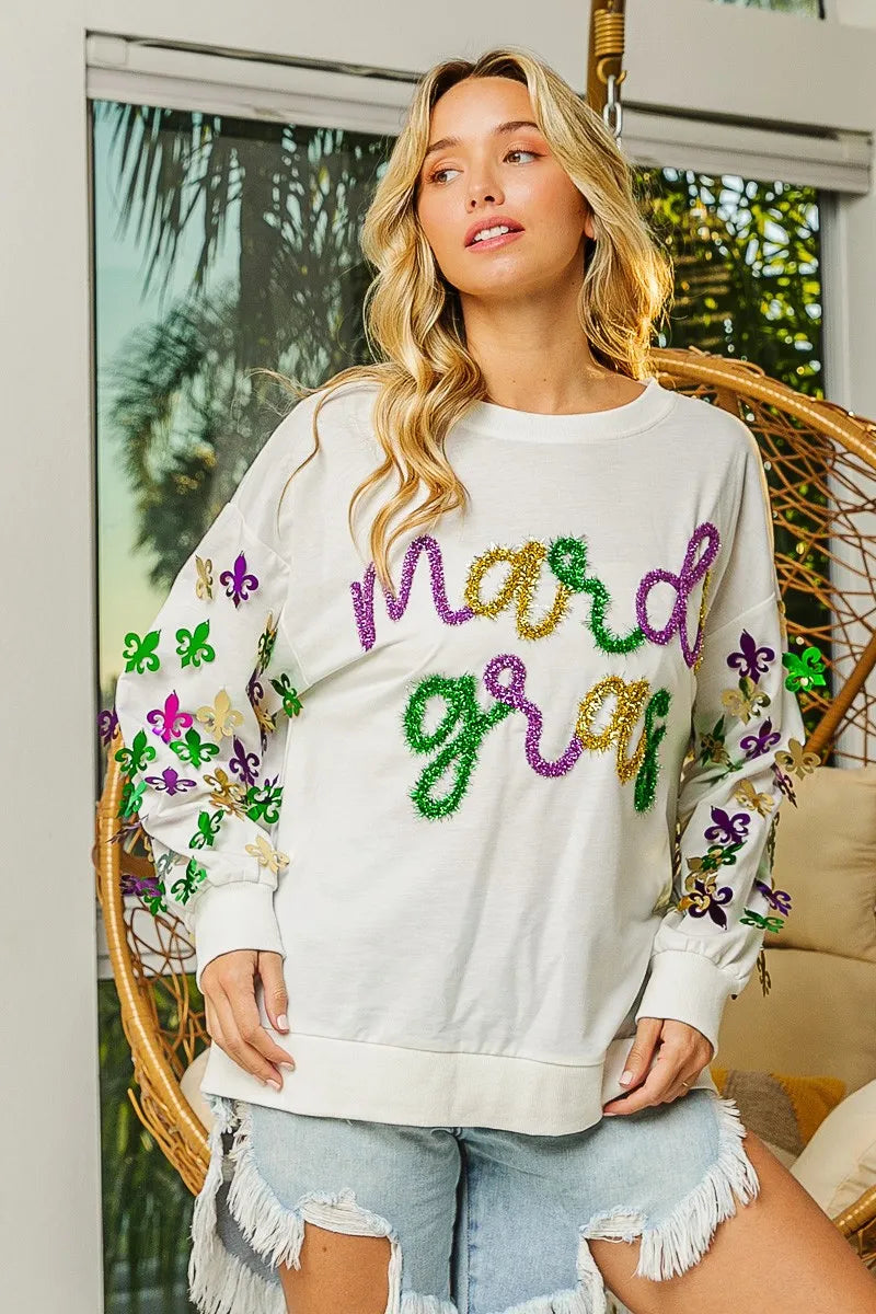 Lightweight pullover with Fleur De Lis sleeve designs in soft-washed fabric for comfort.