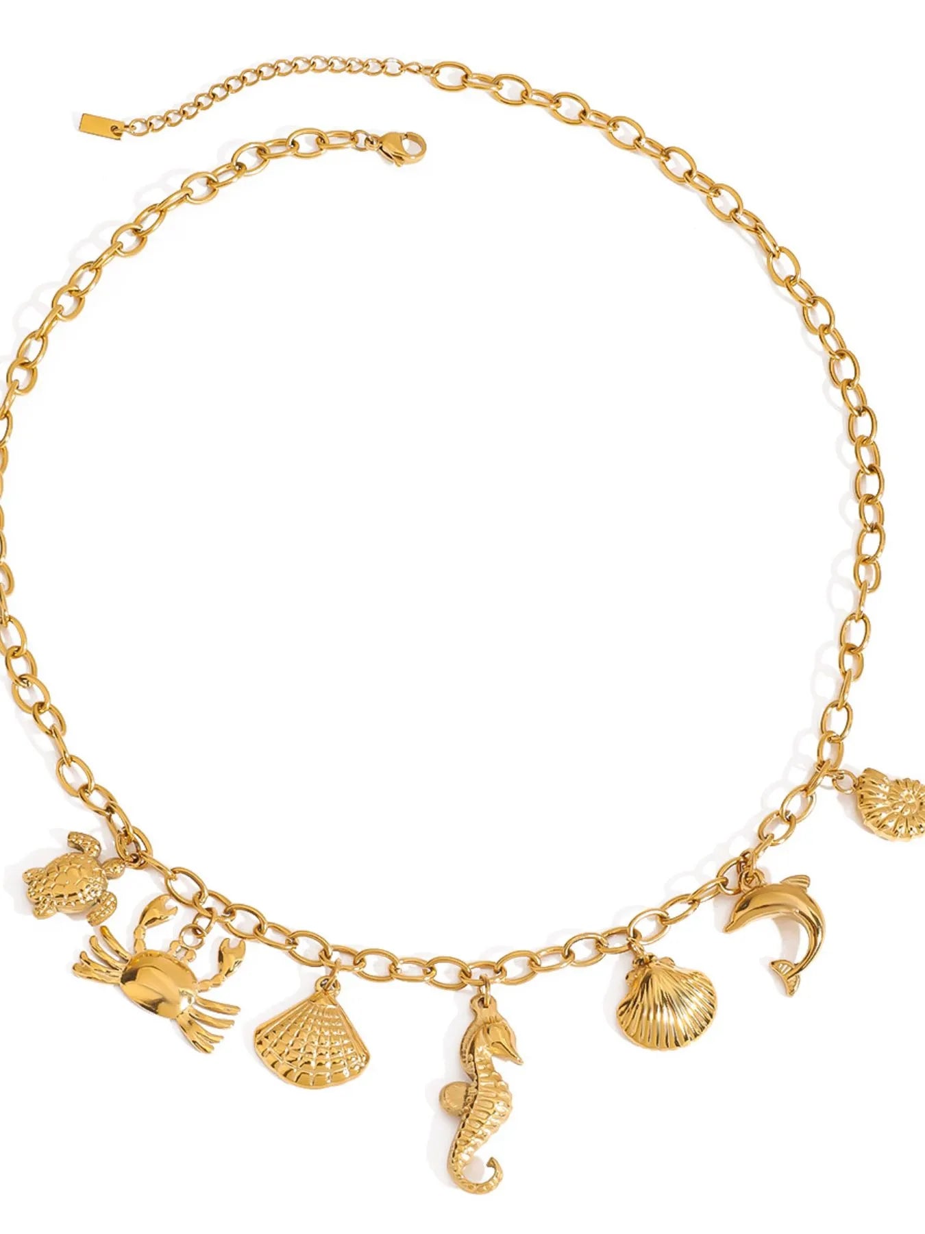 18K gold-plated stainless steel necklace with ocean-themed charms including shells, seahorse, crab, and dolphin.