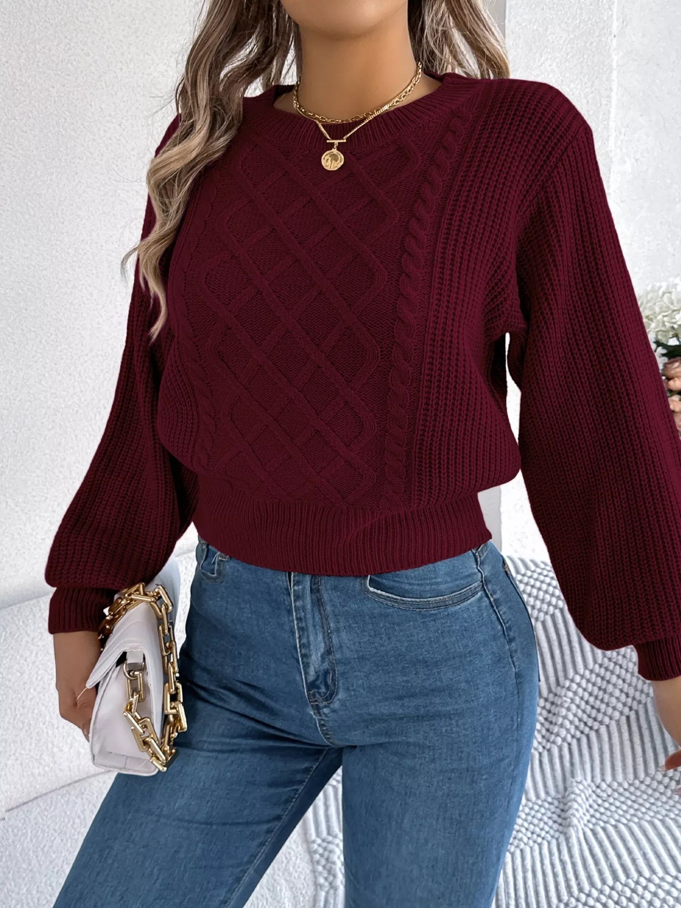 Long sleeve acrylic sweater with cable knit diamond pattern in neutral color