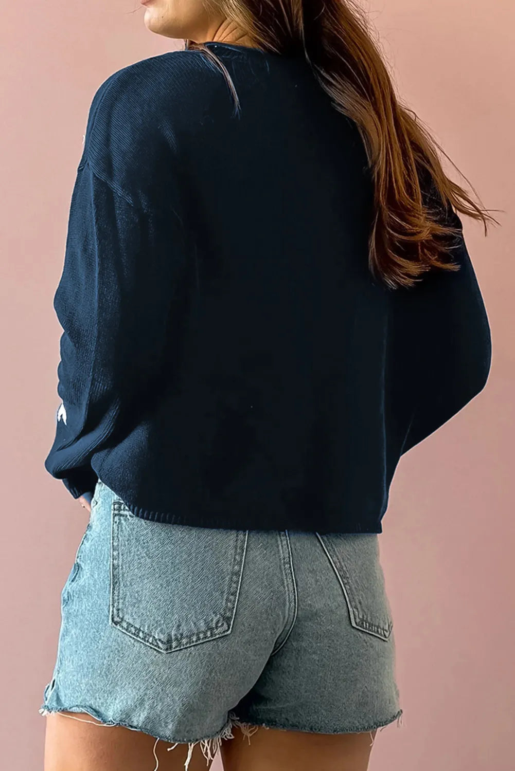 A soft cotton long sleeve sweater in a basic style with a relaxed fit and timeless design.