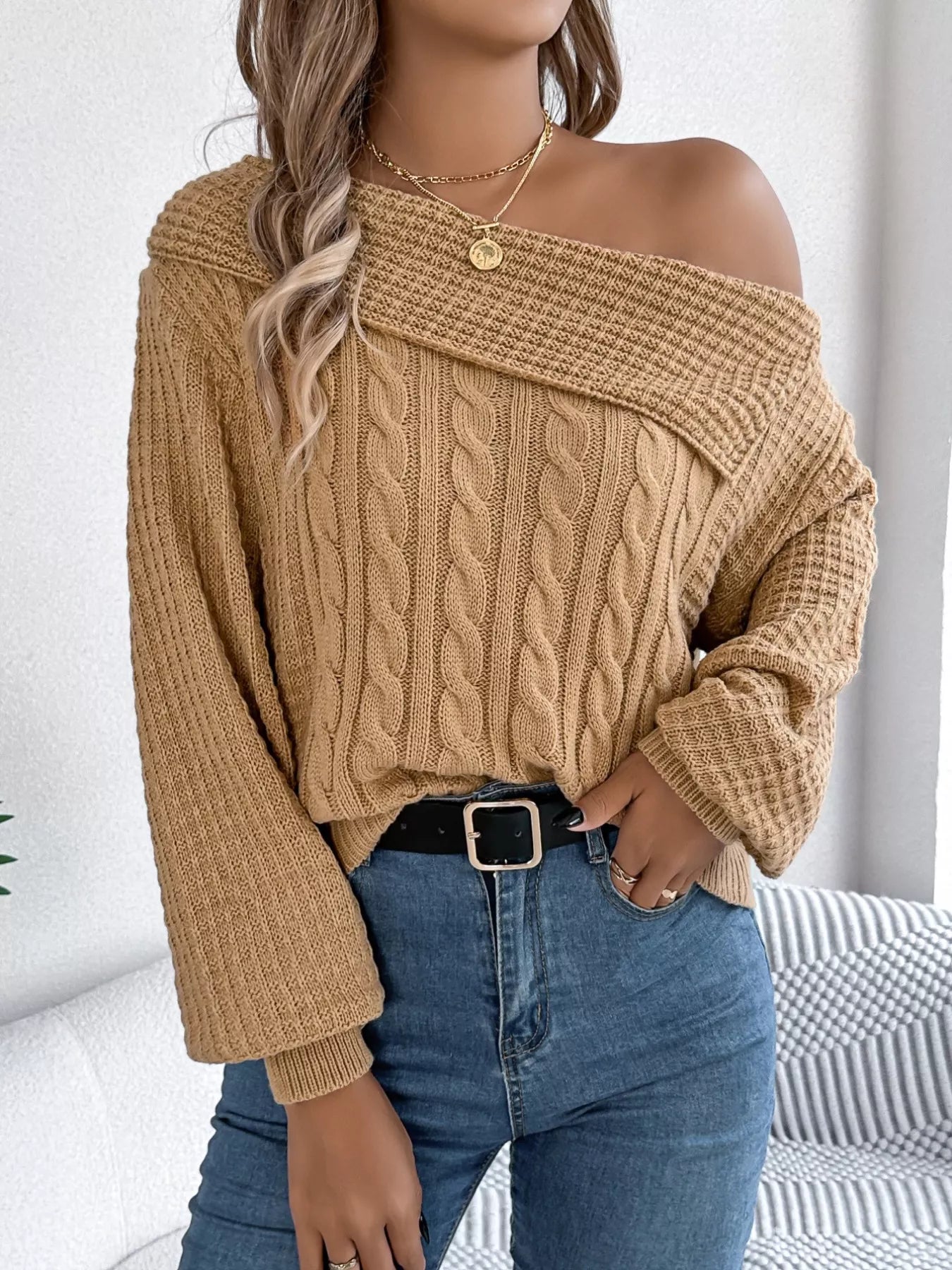 Light gray off-shoulder sweater with cable knit texture and slightly stretchy acrylic fabric.