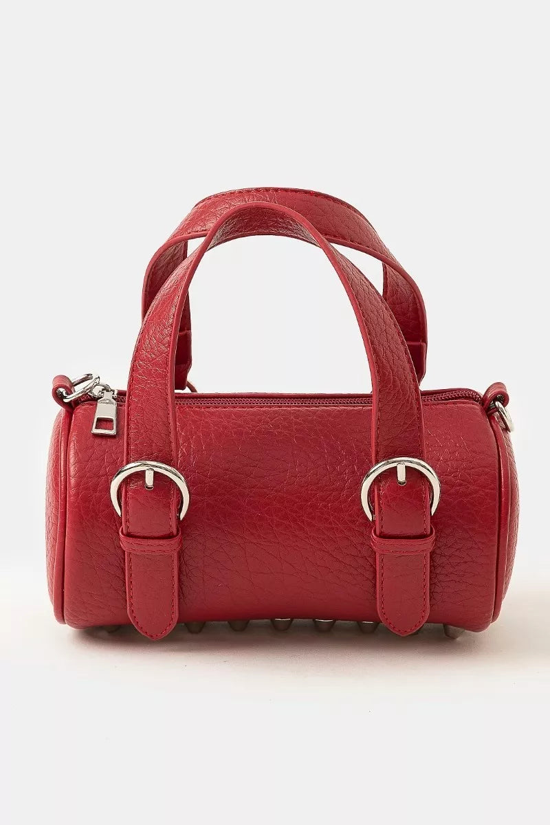 Burgundy faux leather mini cylinder bag with silver buckles and double handles.