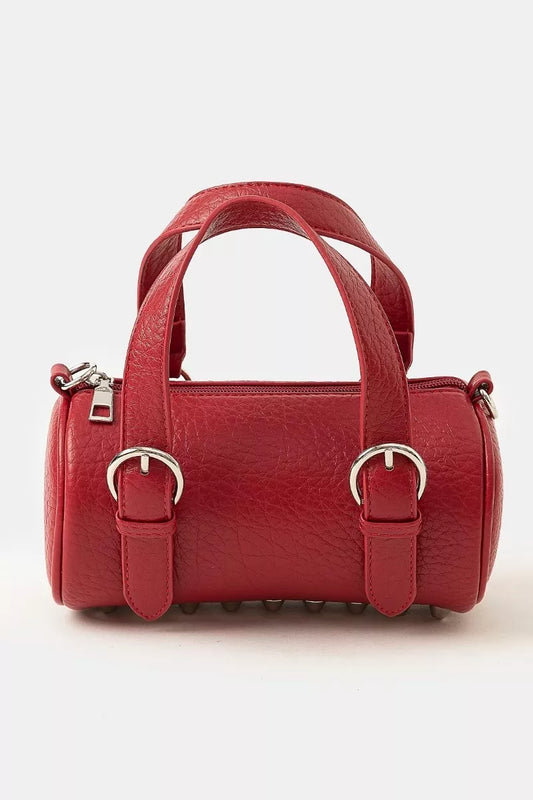 Burgundy faux leather mini cylinder bag with silver buckles and double handles.