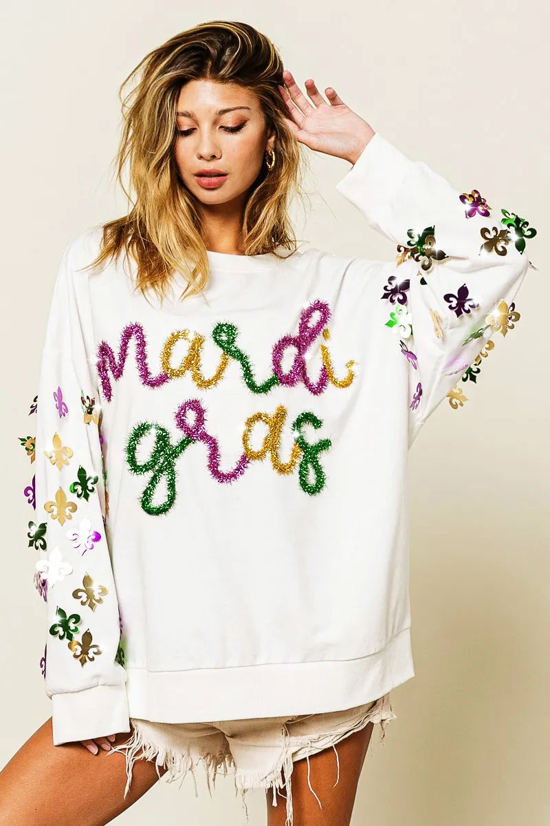 A soft pullover with Fleur De Lis designs on the sleeves, perfect for Mardi Gras celebrations.
