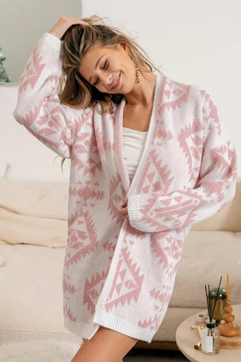 Pink open-front acrylic cardigan with Aztec pattern, modeled on a woman.