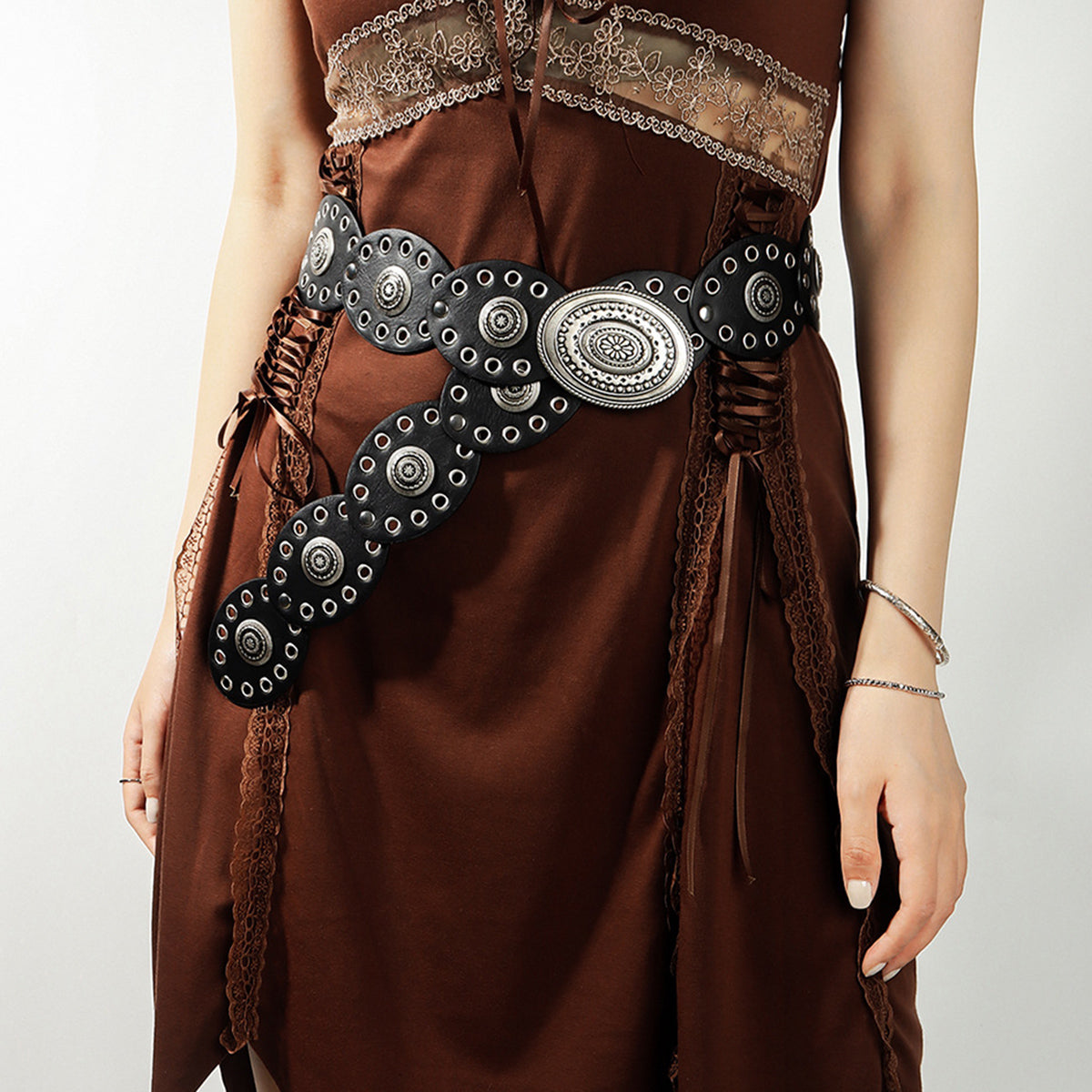 Oval PU leather belt with concho details on a bohemian brown dress.