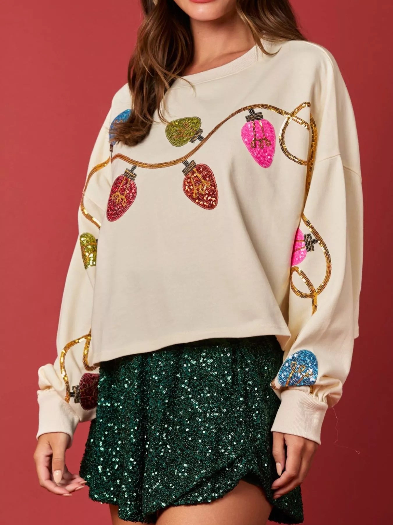 Gray sweatshirt with sequin embellishments, featuring a relaxed fit and long sleeves.