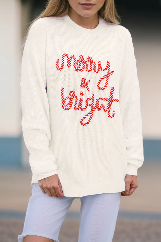 Cream round neck sweater with red "Merry & Bright" text, modeled on a woman.