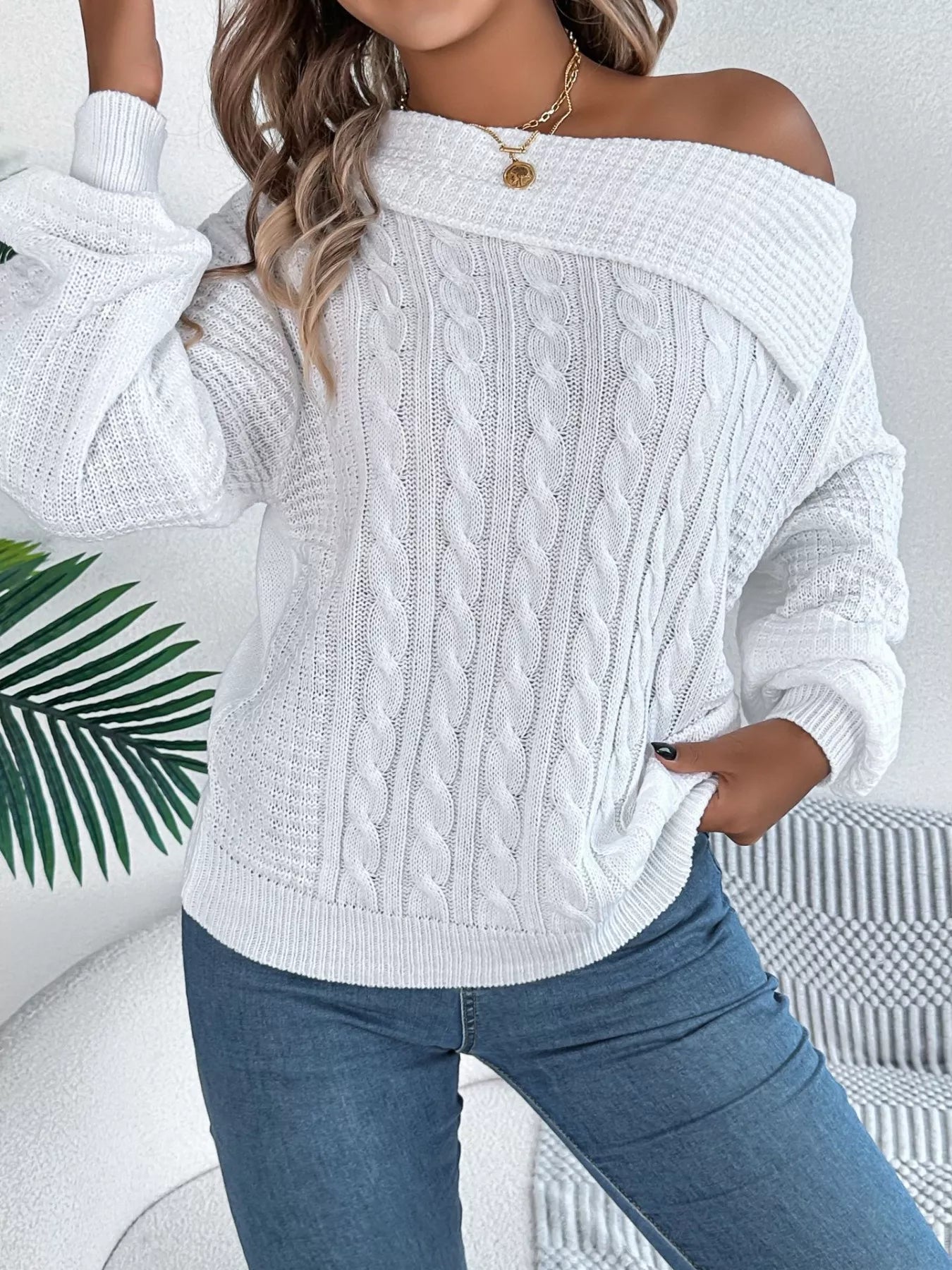 Off-shoulder cable knit sweater in soft, slightly stretchy acrylic for a relaxed fit.