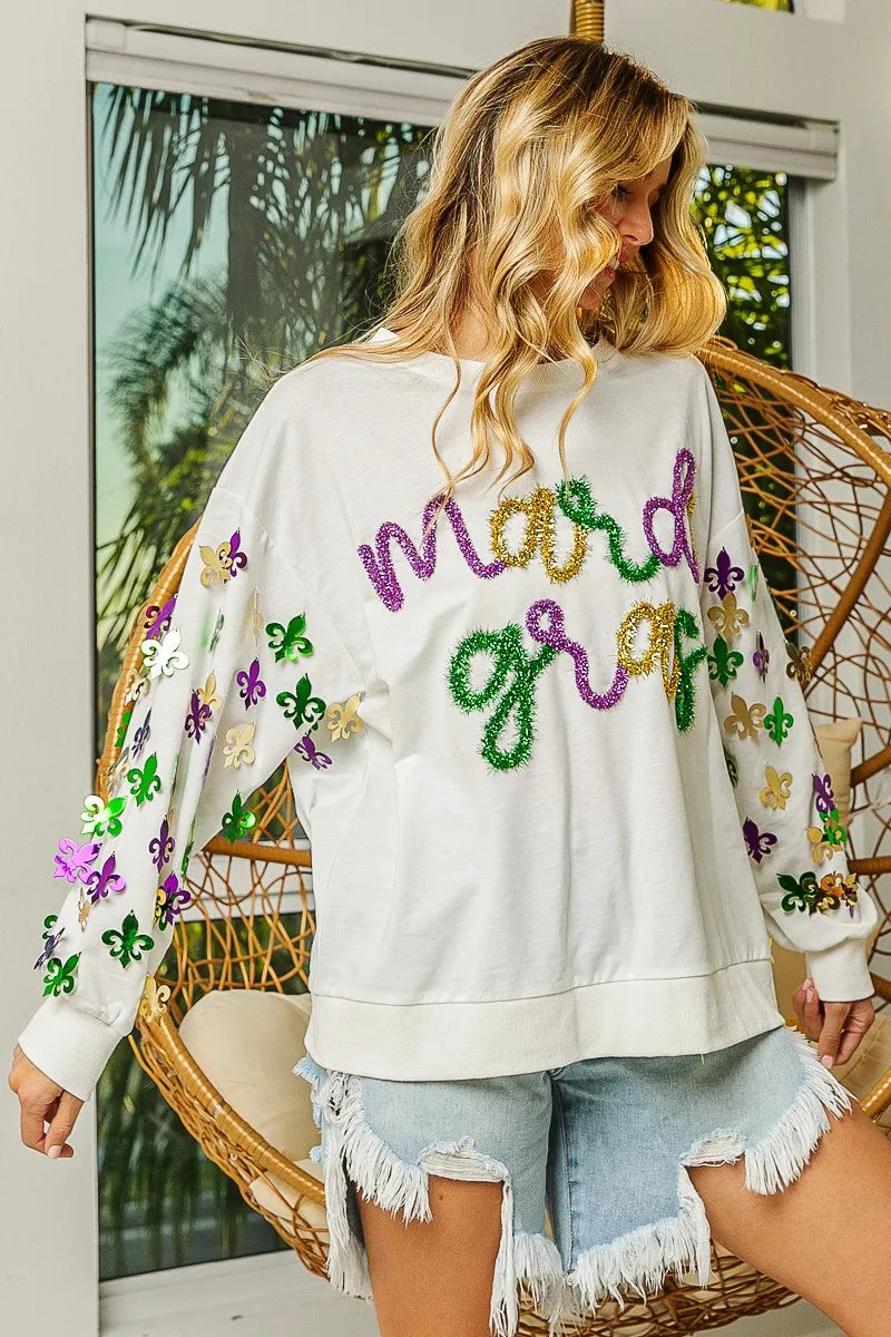 Long-sleeve pullover with Fleur De Lis designs on sleeves in soft fabric for Mardi Gras wear