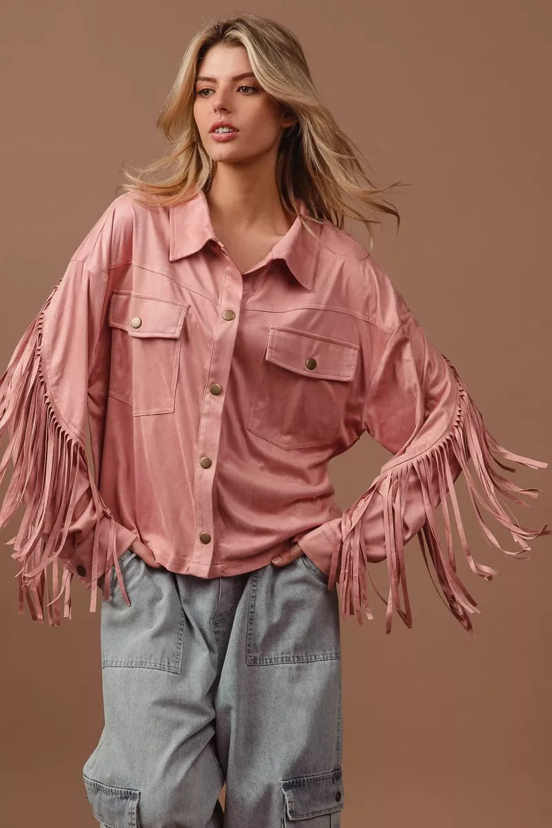 BiBi suede fringe long sleeve jacket in pink, worn over gray pants.