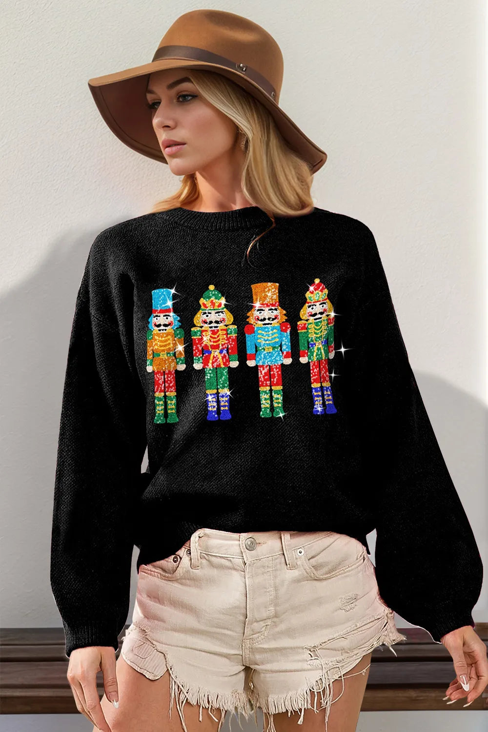 Blush sequin nutcracker long sleeve sweater on model with shorts.