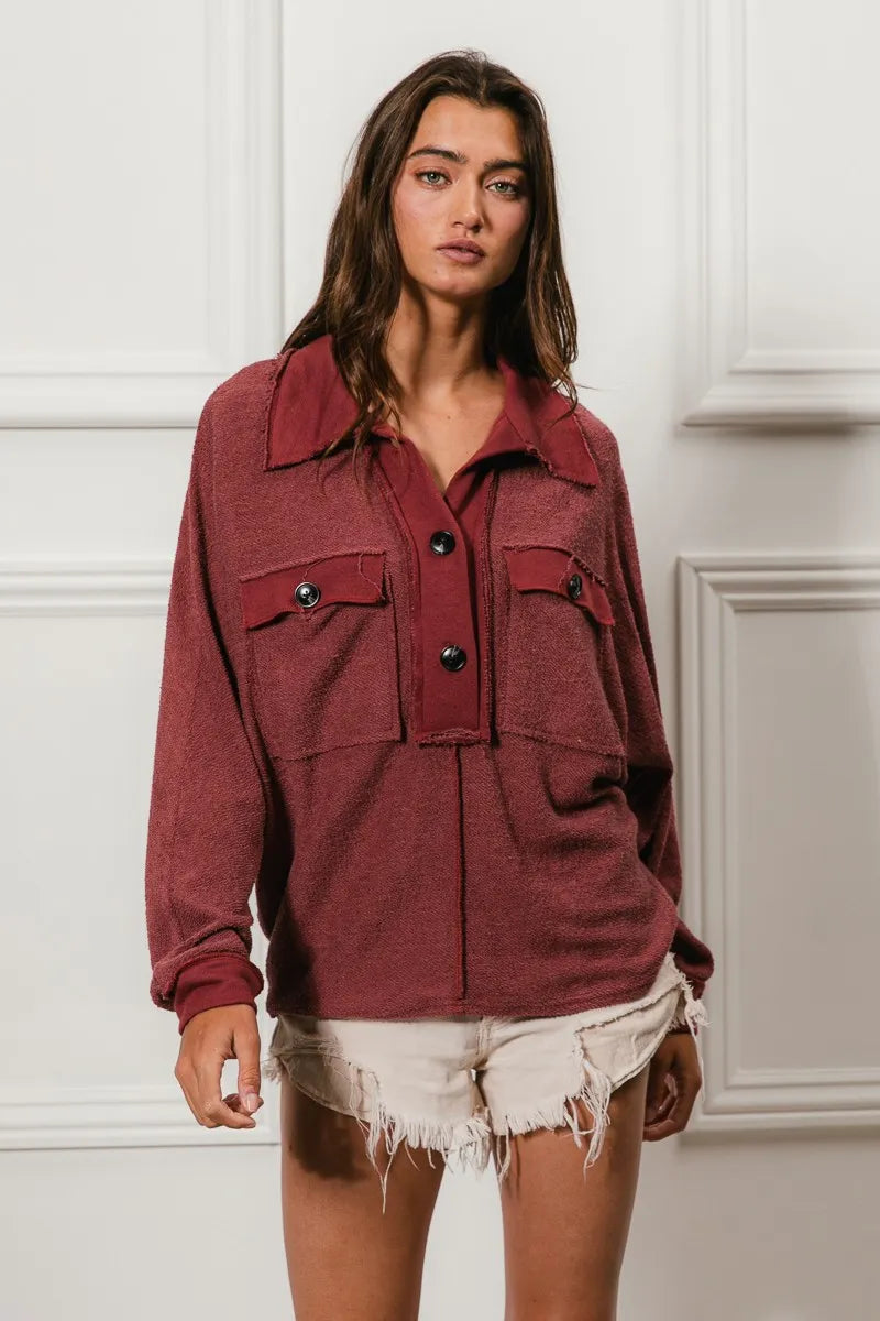 Oversized maroon French terry collared top with buttons and pockets, model in white shorts.