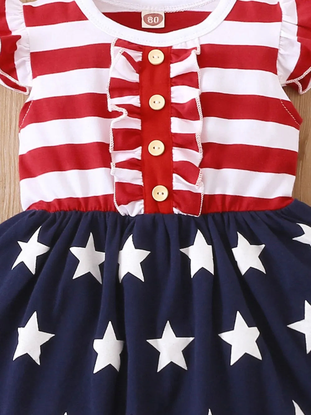 Striped stars ruffled cap sleeve dress made of polyester blend with decorative buttons