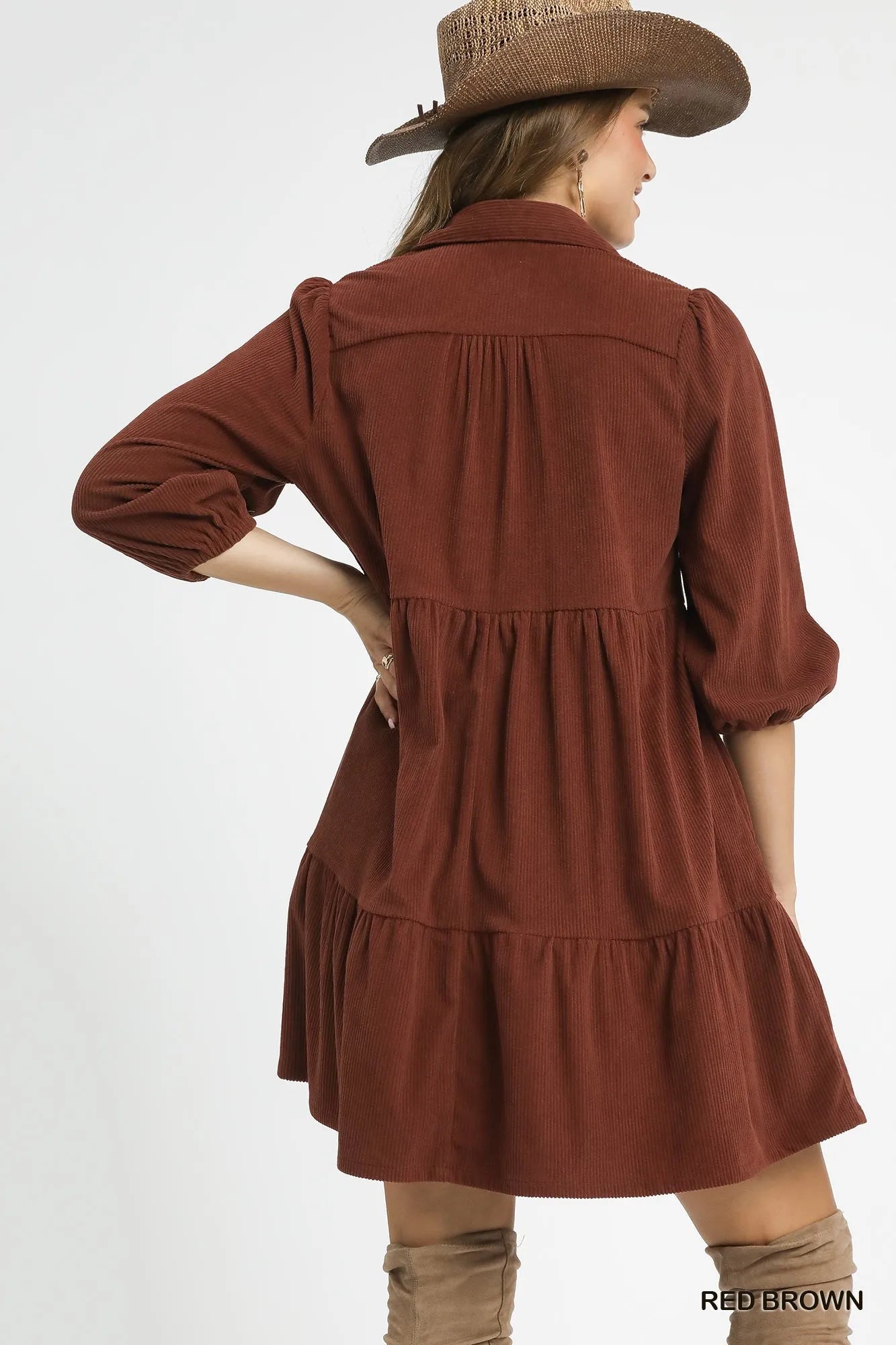 Rear view of a brown corduroy tiered mini dress with balloon sleeves.