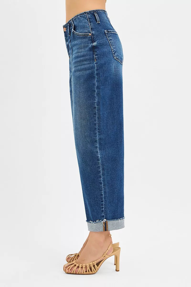 Side view of high-rise barrel cuffed jeans in stretch denim on a model.