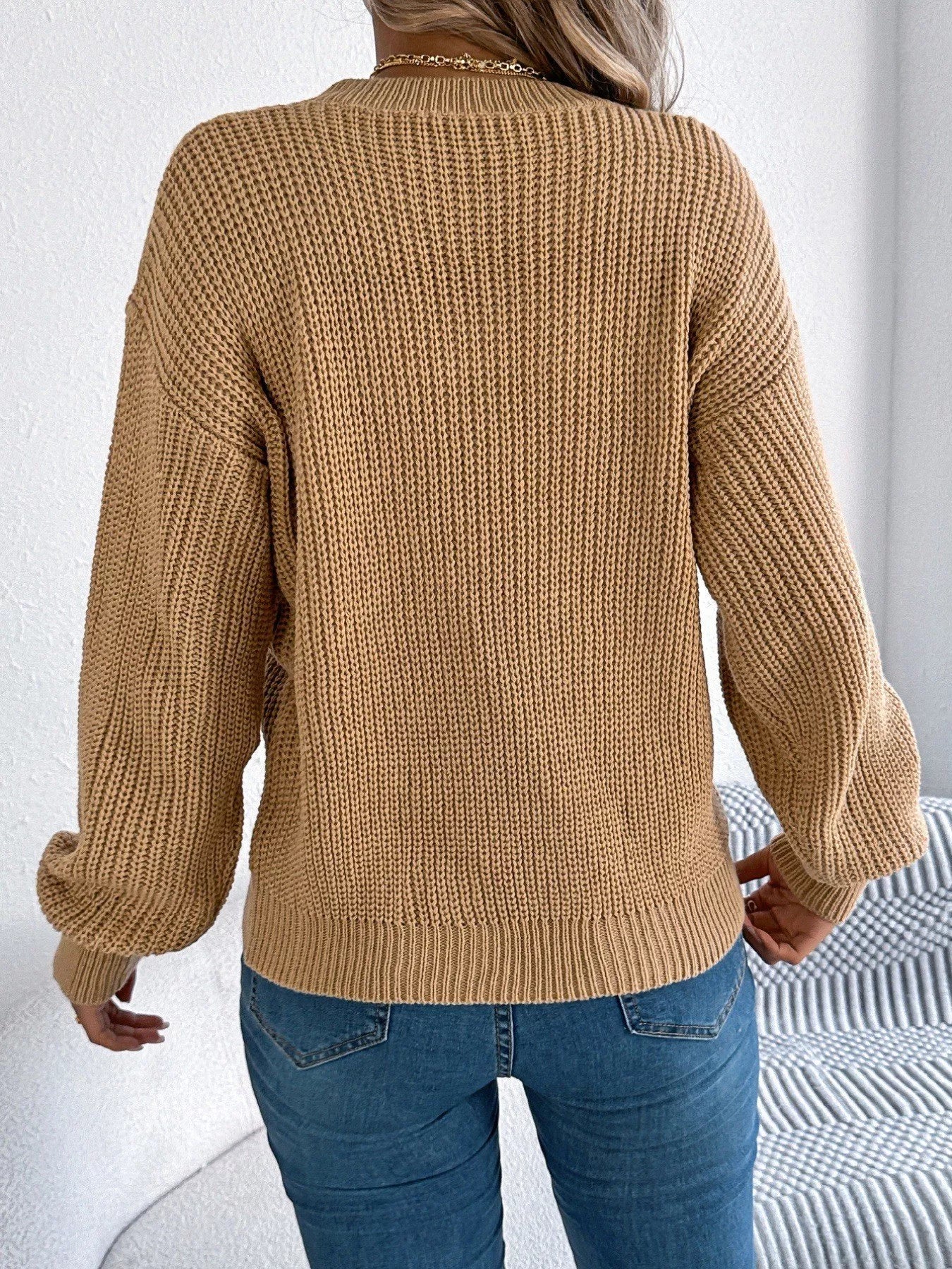 Lightweight openwork acrylic sweater with a round neck and slightly stretchy fit.