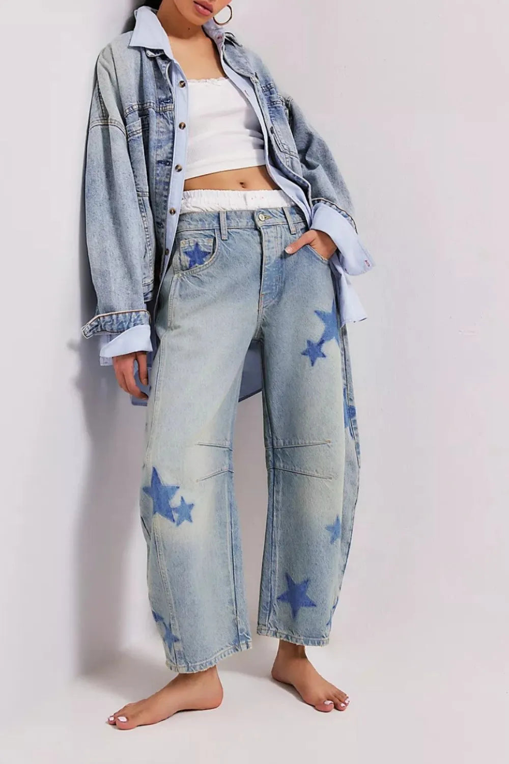 Wide leg jeans with contrast stars, made from a rayon blend, featuring pockets.