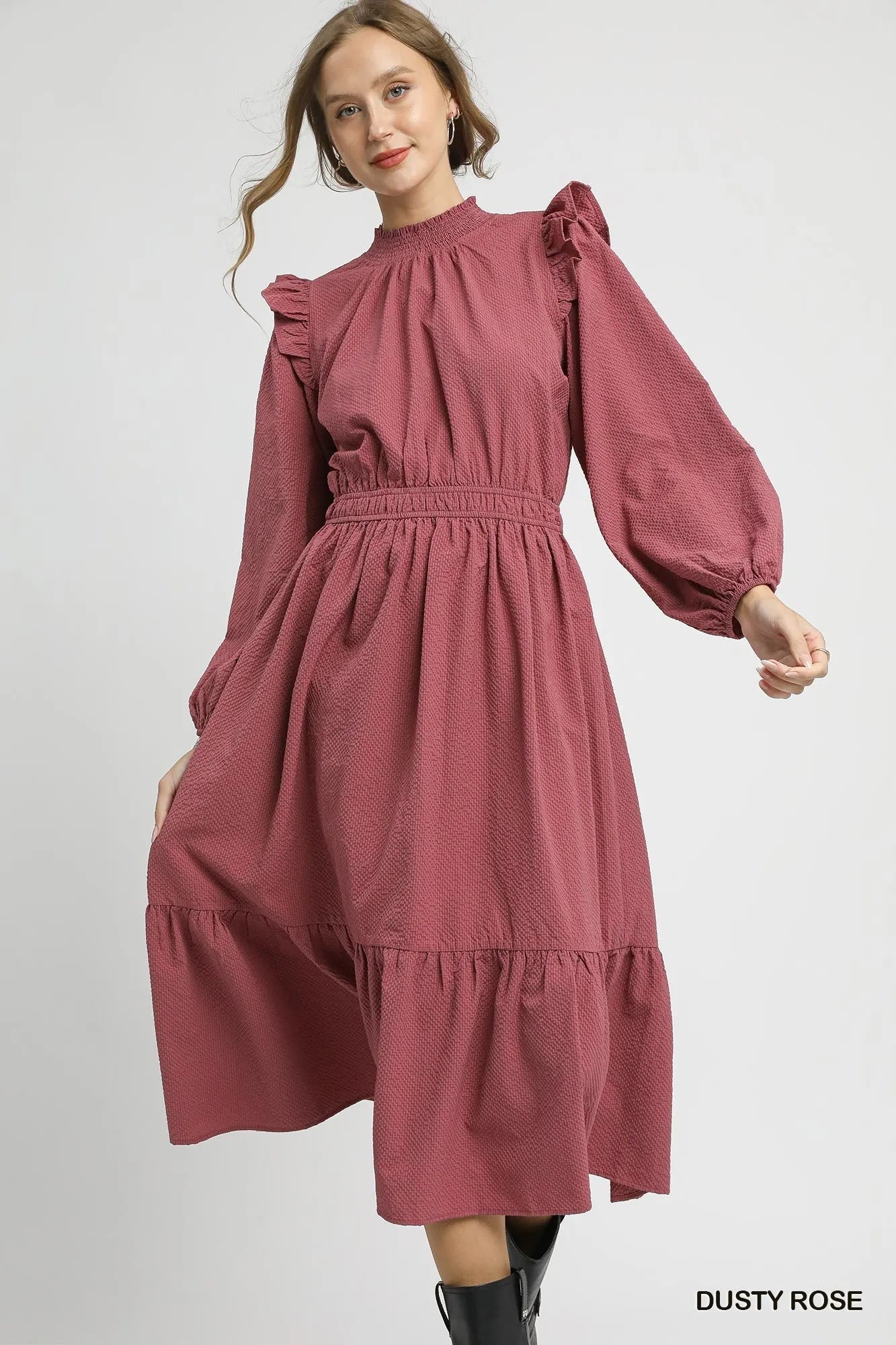 Dusty rose textured midi dress with ruffle shoulders and puffed sleeves on model.