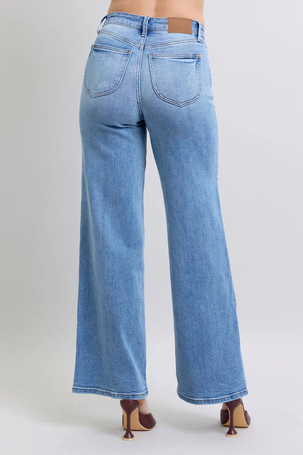 Rear view of Judy Blue high-waist wide-leg jeans with pockets, modeled on a person.