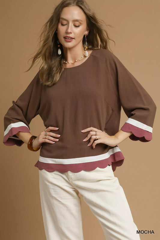 Woman modeling brown and white scalloped hem color block linen blend top with 3/4 sleeves.