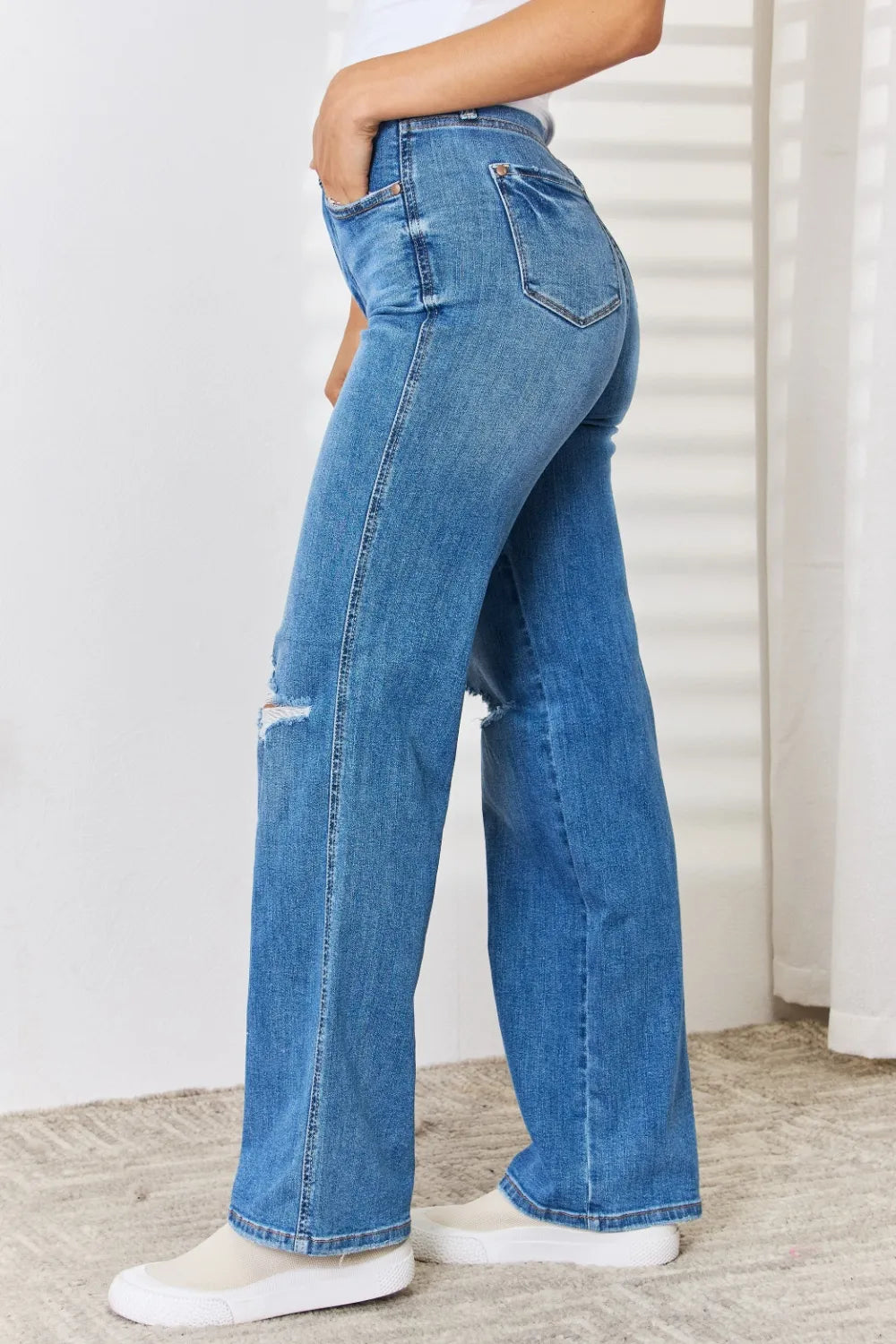 Side view of Judy Blue high-waist distressed straight-leg jeans on a model.