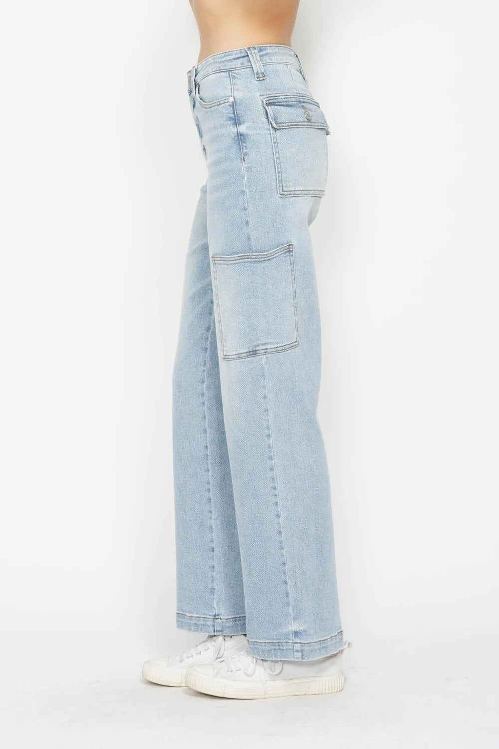 High-waist straight-leg cargo jeans in light wash with multiple pockets, model side view.