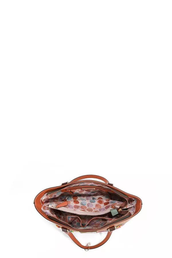 Open top-down view of tropical print vegan leather shopper bag with patterned lining.