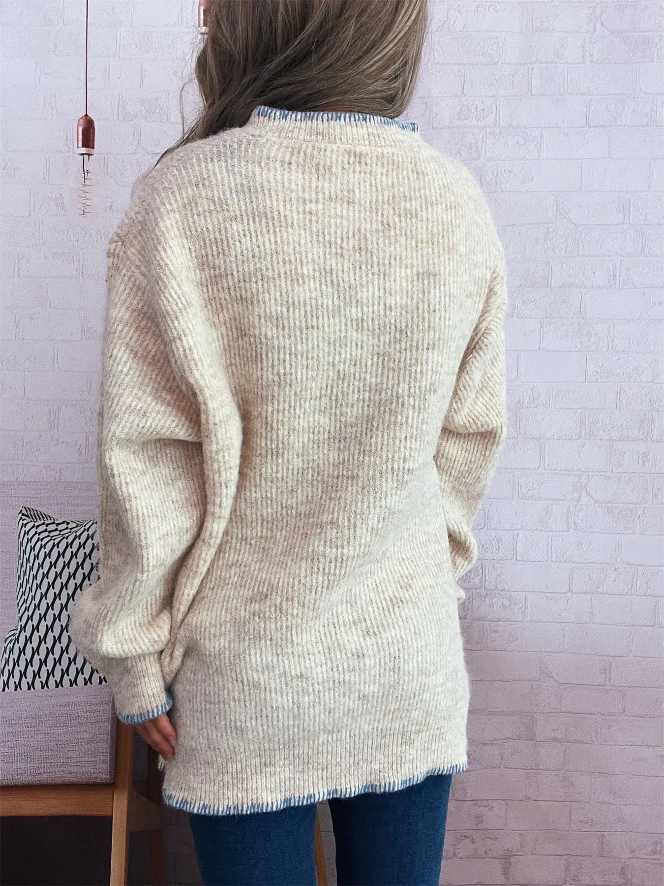 Oversized ribbed sweater with button detail and contrast stitching in soft polyester.