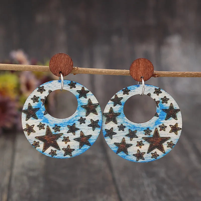 Wooden dangle earrings with a cutout star print, made of alloy and wood.