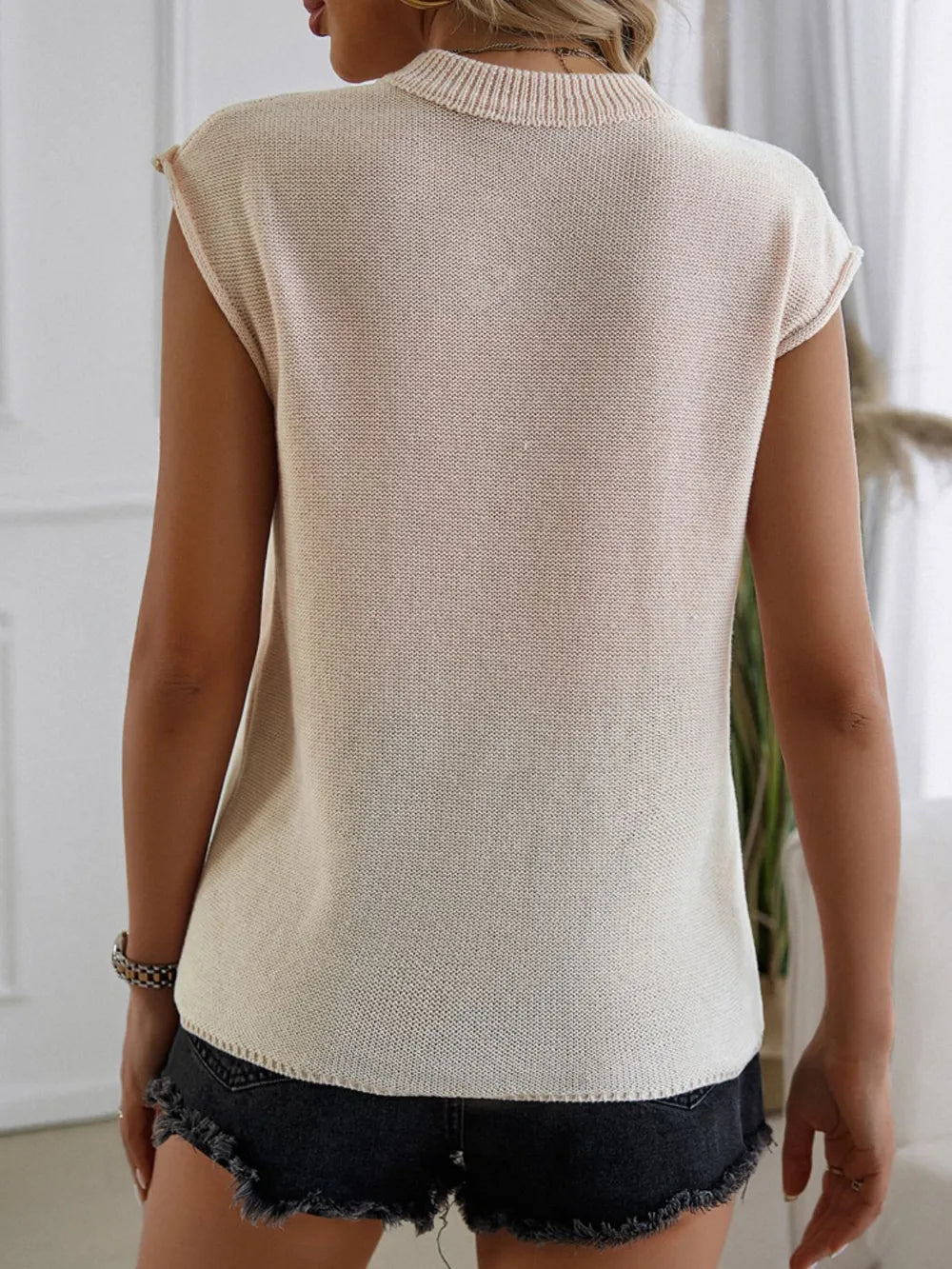Polyester sweater vest with US flag design, round neck, and moderate stretch fabric.