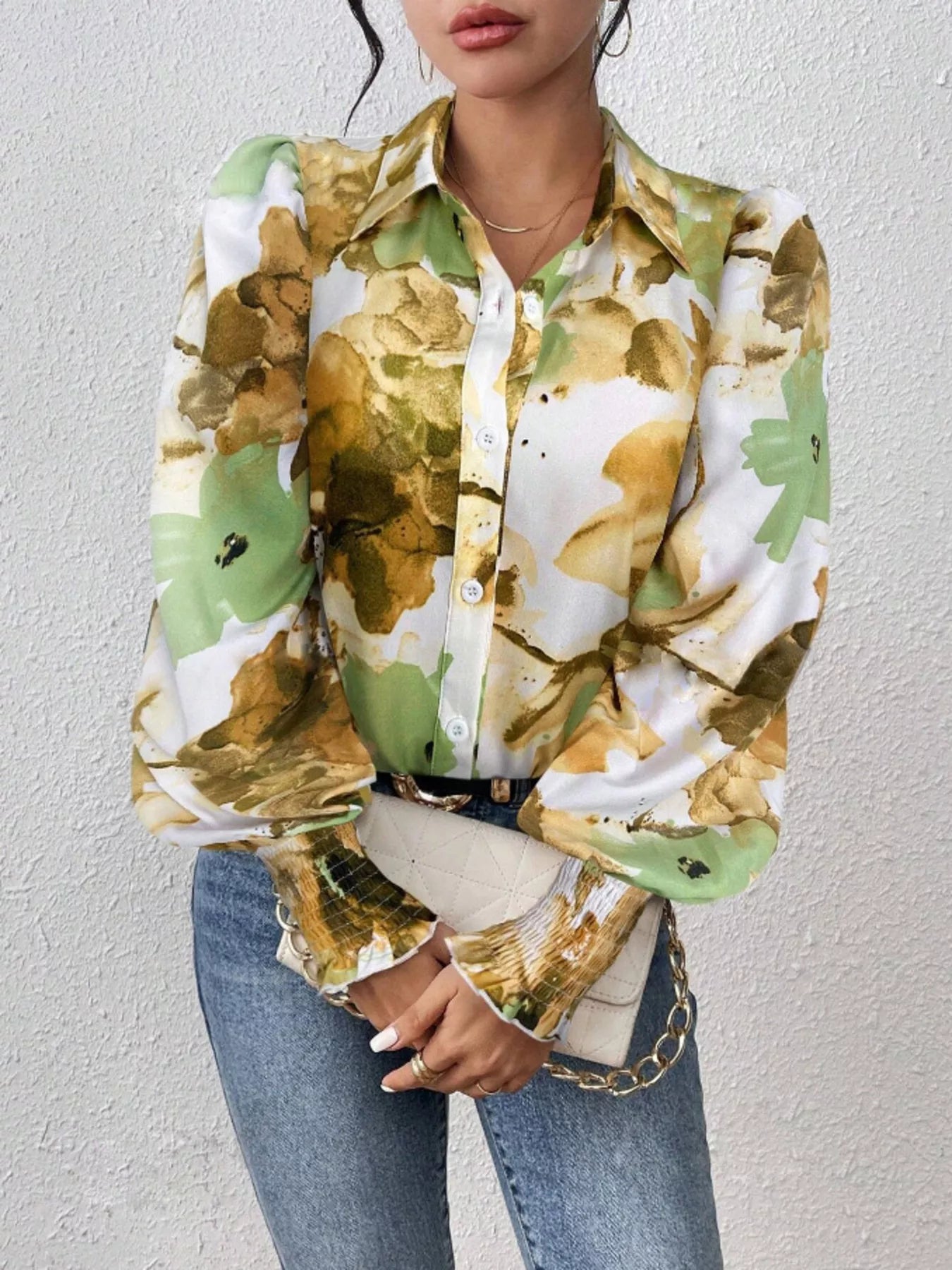 Lightweight button-up shirt with printed design and lantern sleeves in a polyester blend.