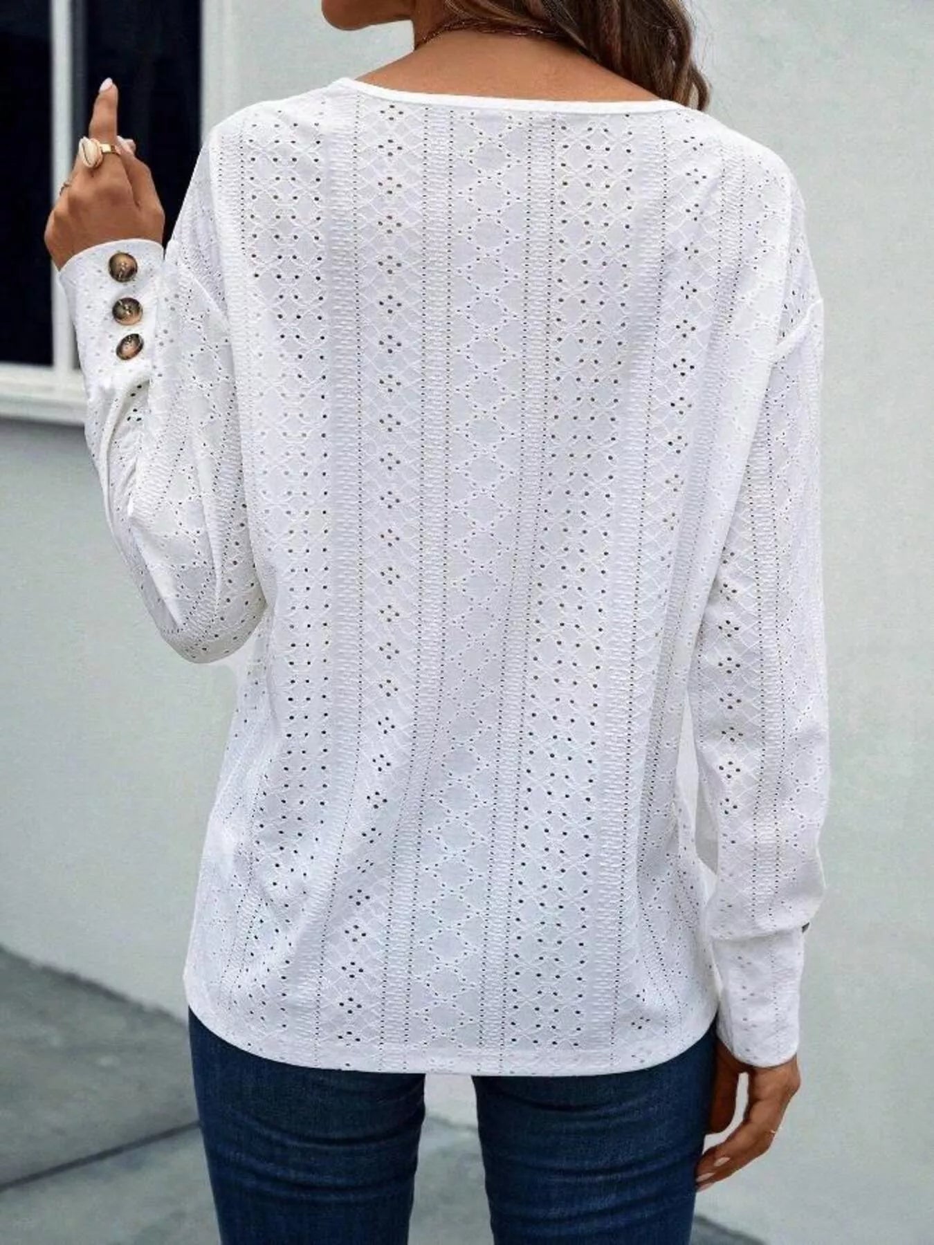 Long sleeve polyester blend blouse with eyelet details and V-neck with decorative buttons