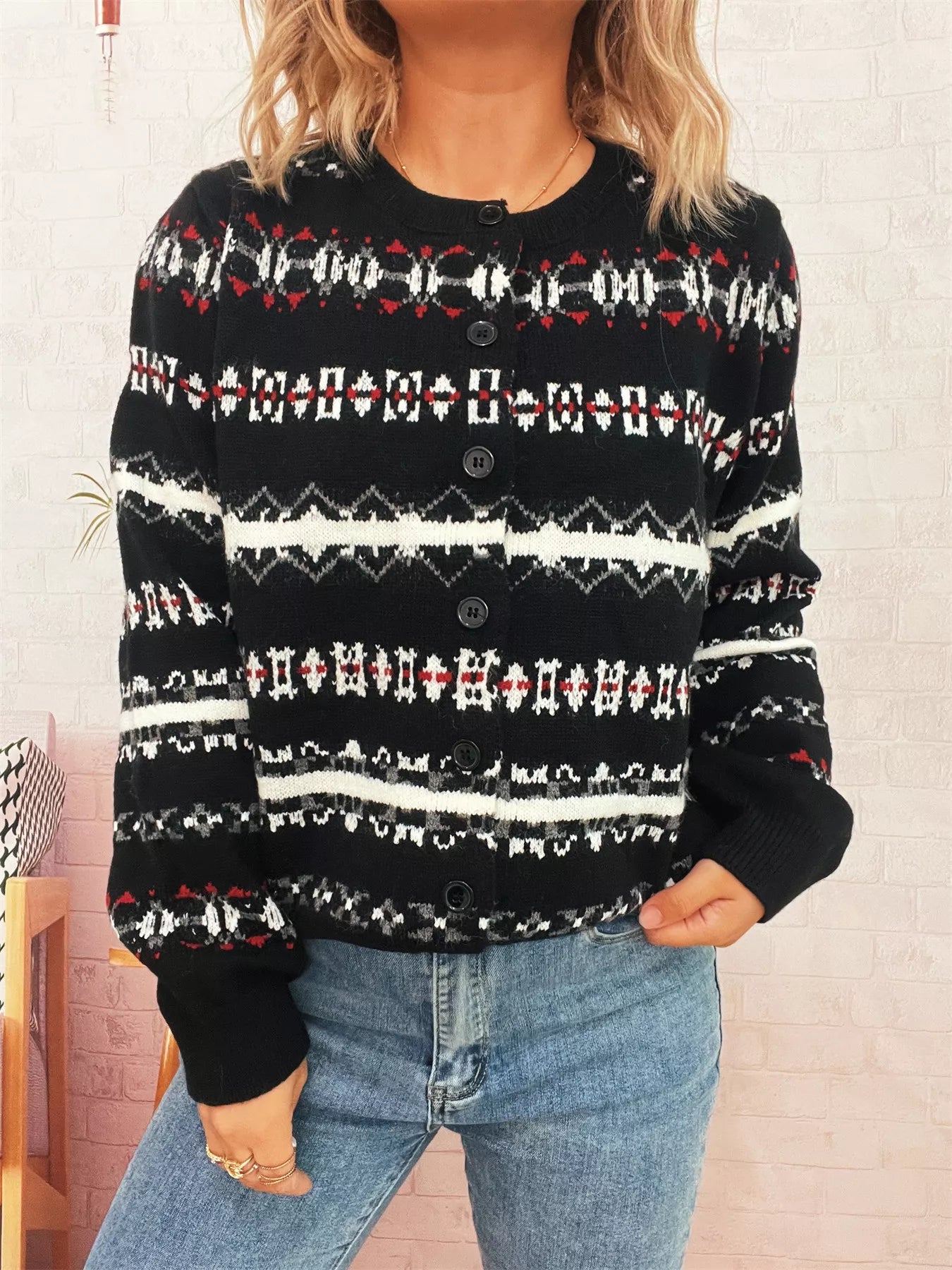 A vintage pattern button-down cardigan made of 100% polyester with slight stretch.