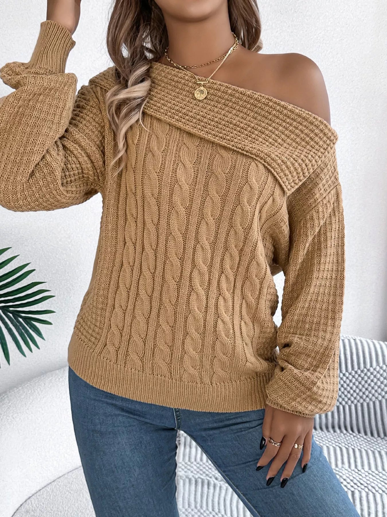 Off-shoulder cable knit sweater in soft acrylic with a relaxed fit and classic texture.