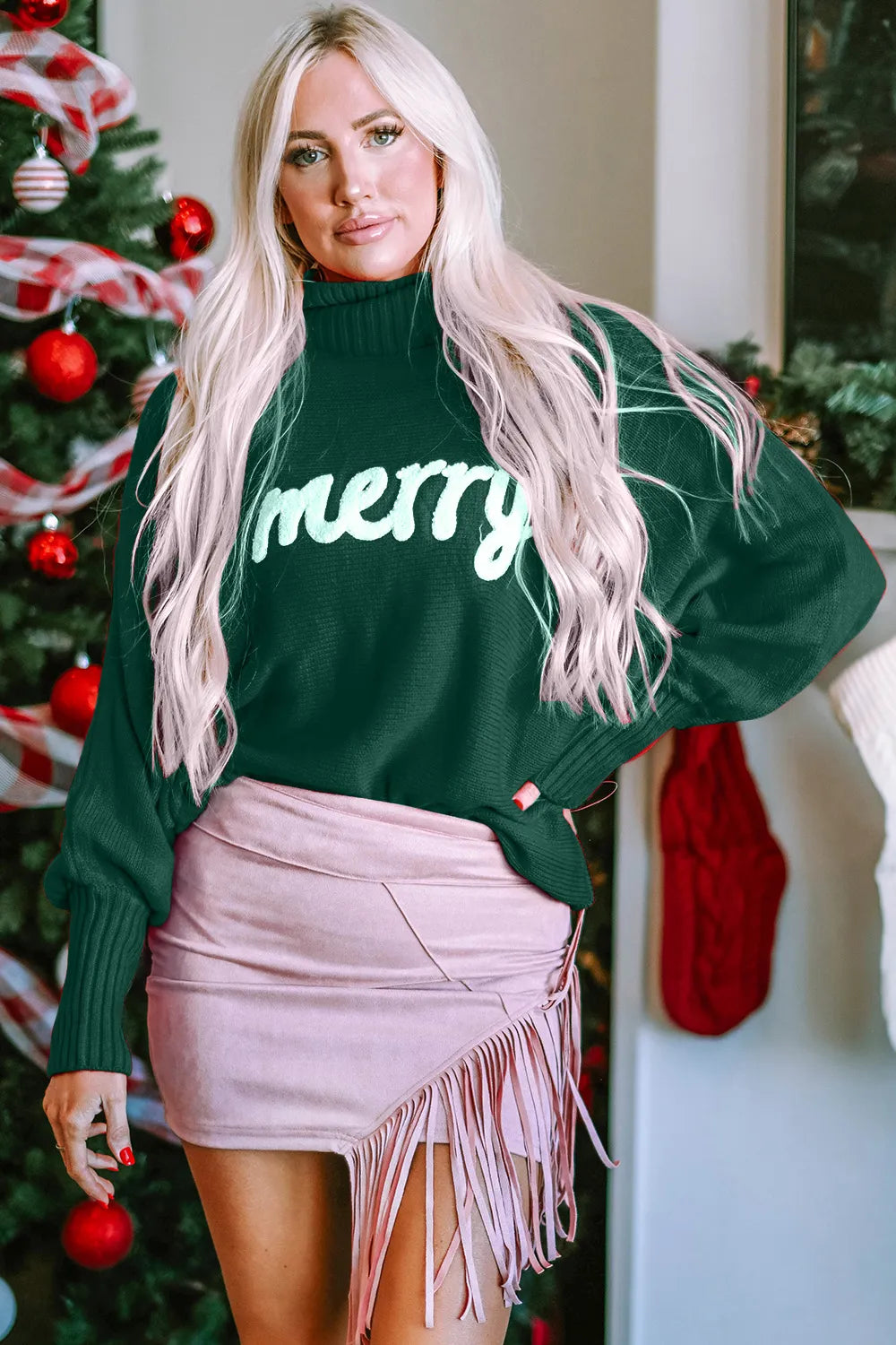 Emerald green turtleneck acrylic sweater with "Merry" text on chest.