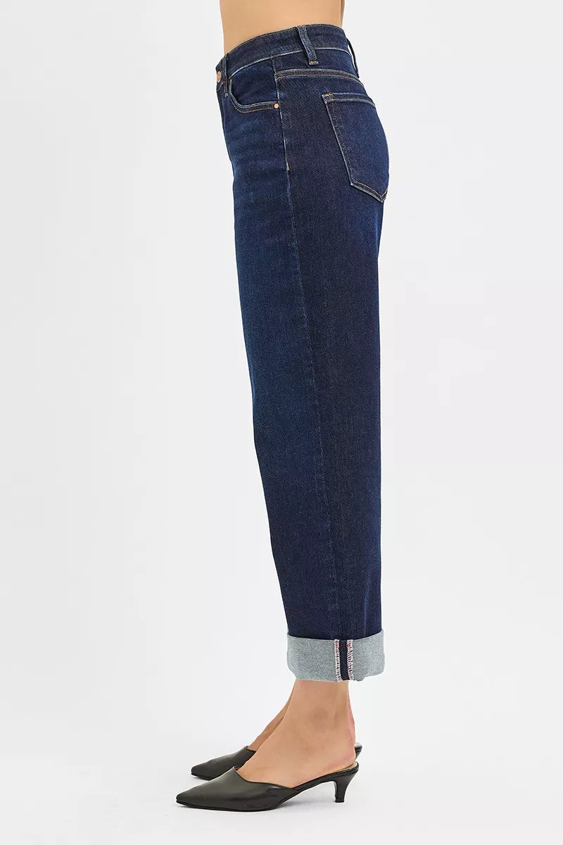 Side view of mid-rise ankle wide-leg jeans with rolled cuffs in dark wash denim.