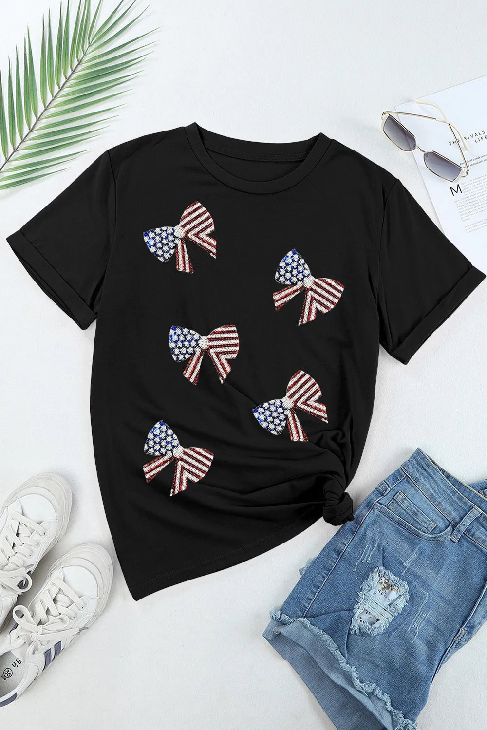 White t-shirt with US flag design, round neck, and short sleeves made from a cotton blend.