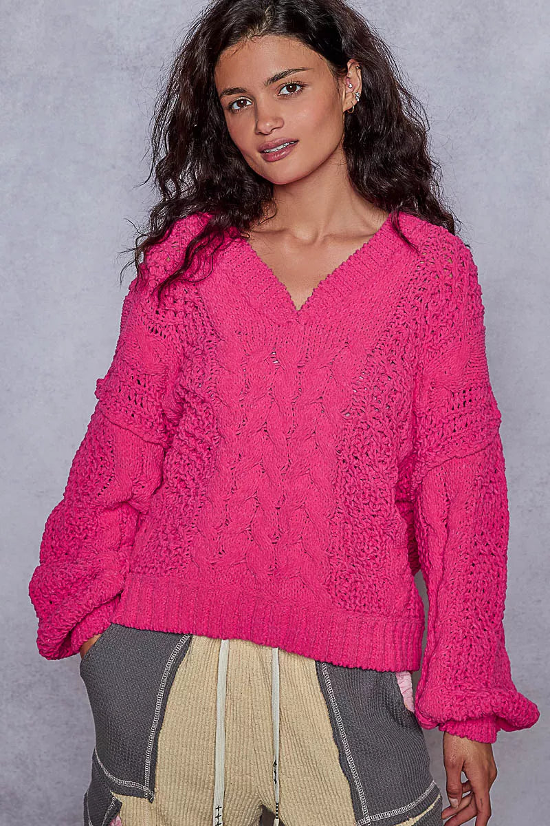 Pink chenille cable-knit V-neck cropped sweater with balloon sleeves on model.