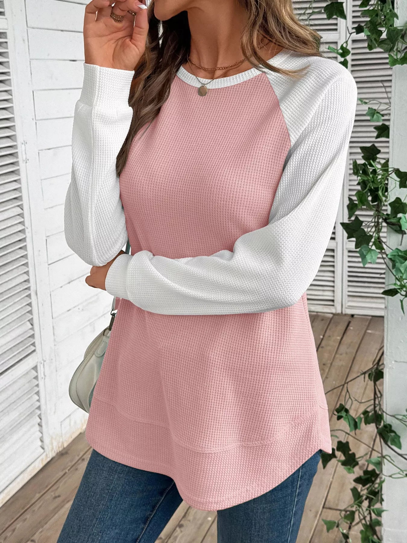 Waffle knit t-shirt with contrast raglan sleeves and slightly stretchy fabric.