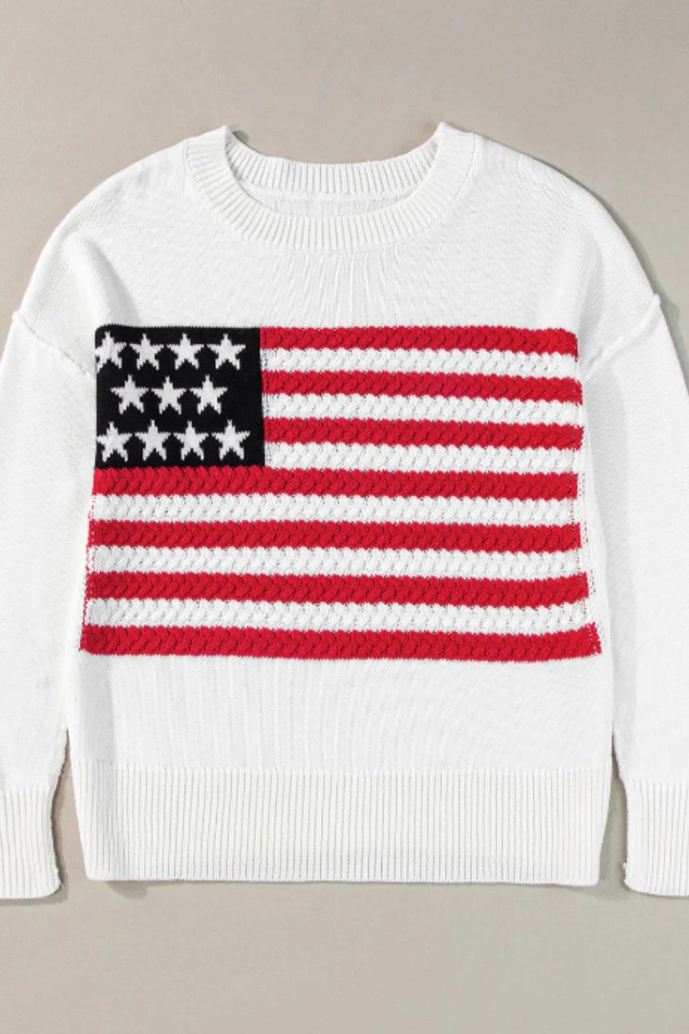 US flag patterned sweater with side slits and drop shoulders in a soft acrylic-cotton blend.