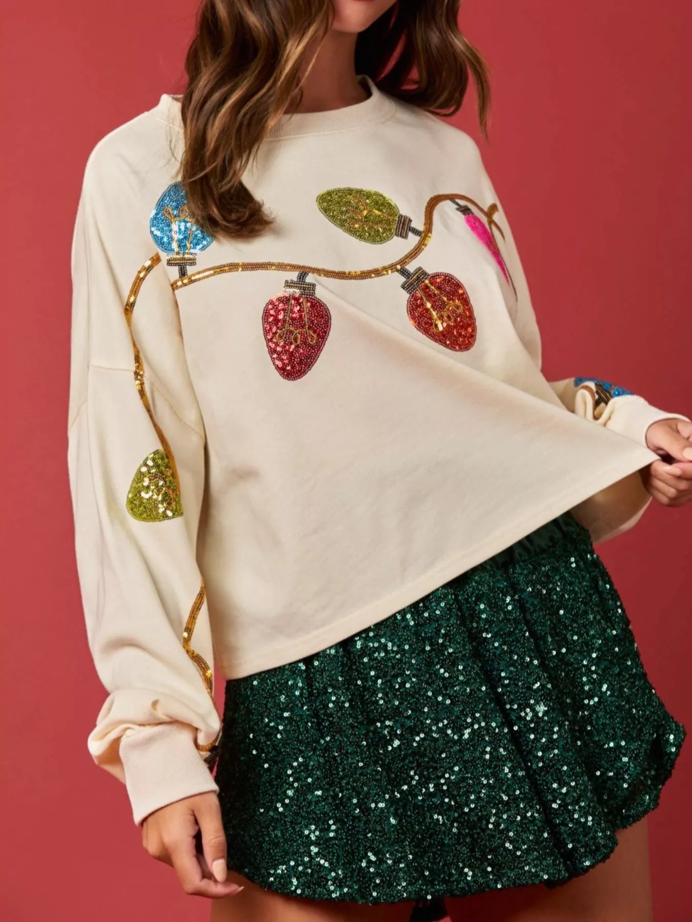 Light gray sweatshirt with sequin embellishments, perfect for holiday casual wear.