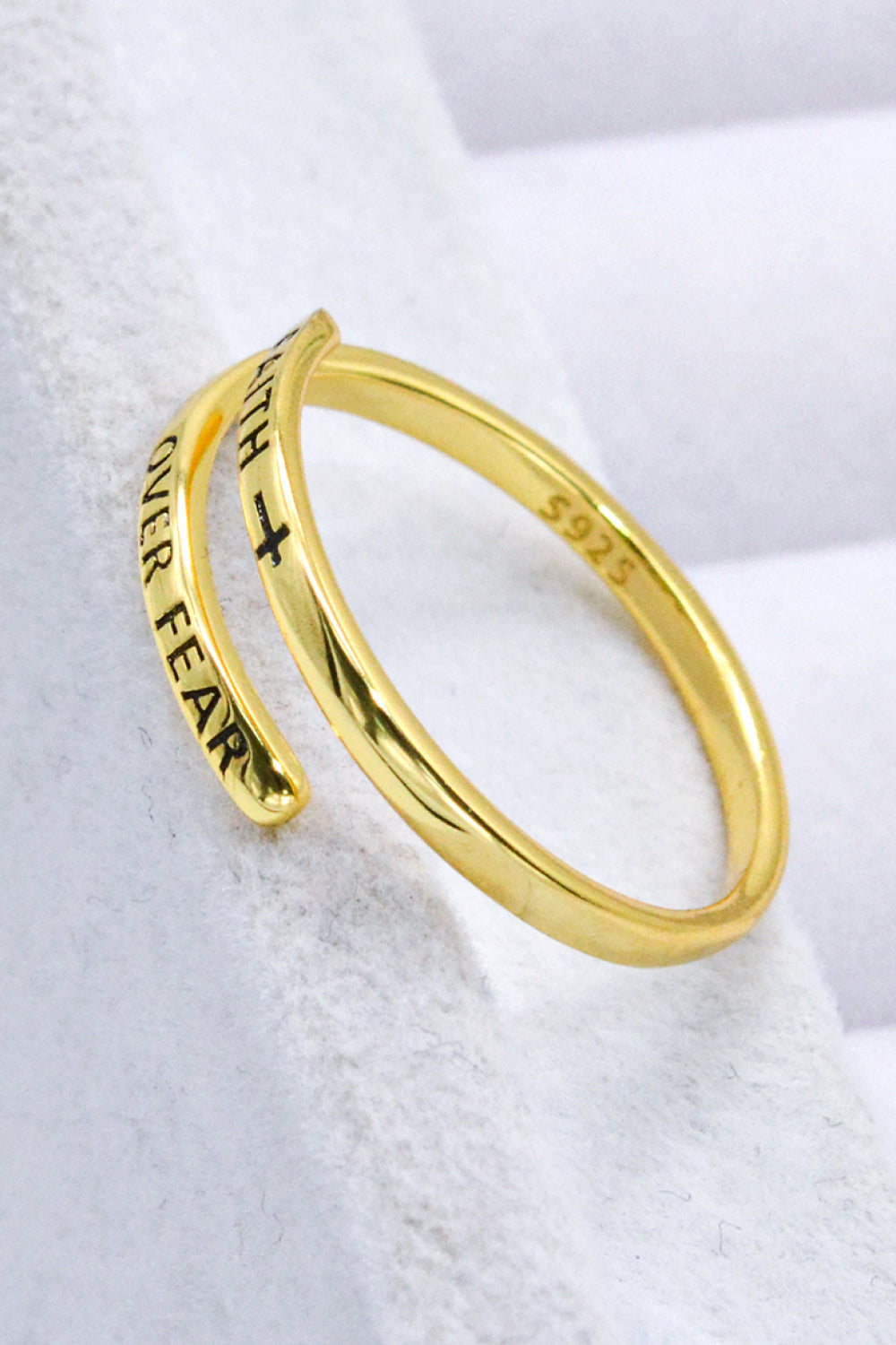 Gold-plated sterling silver bypass ring engraved with "Faith Over Fear" and a cross.