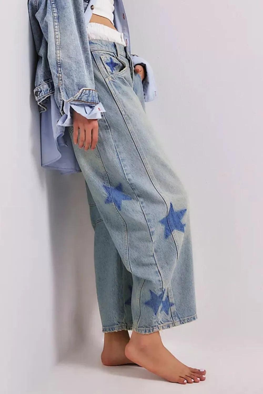 Wide leg jeans with a contrast star design, made from a rayon blend fabric.