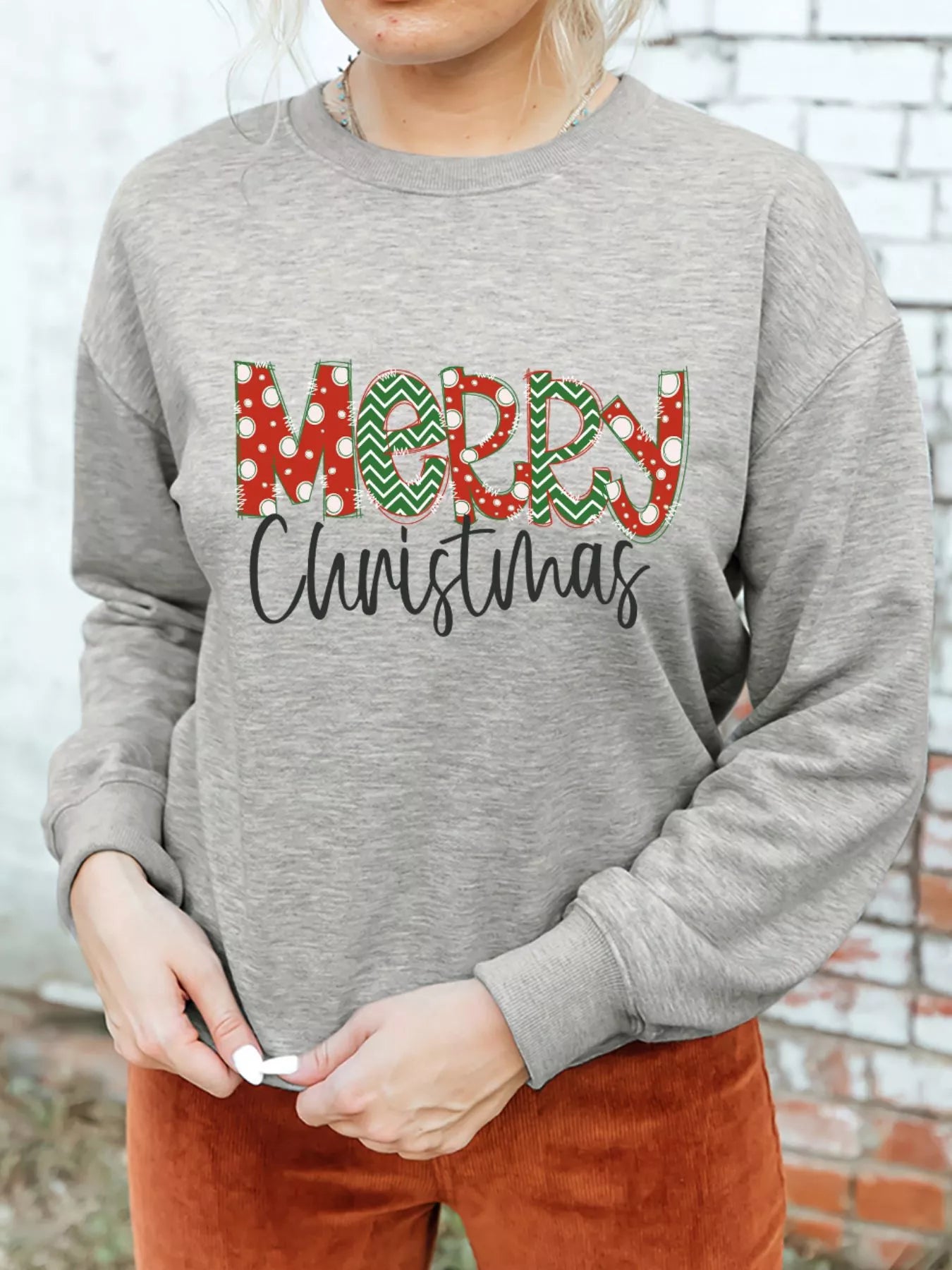 A cotton blend sweatshirt with a festive letter print and drop shoulder design.