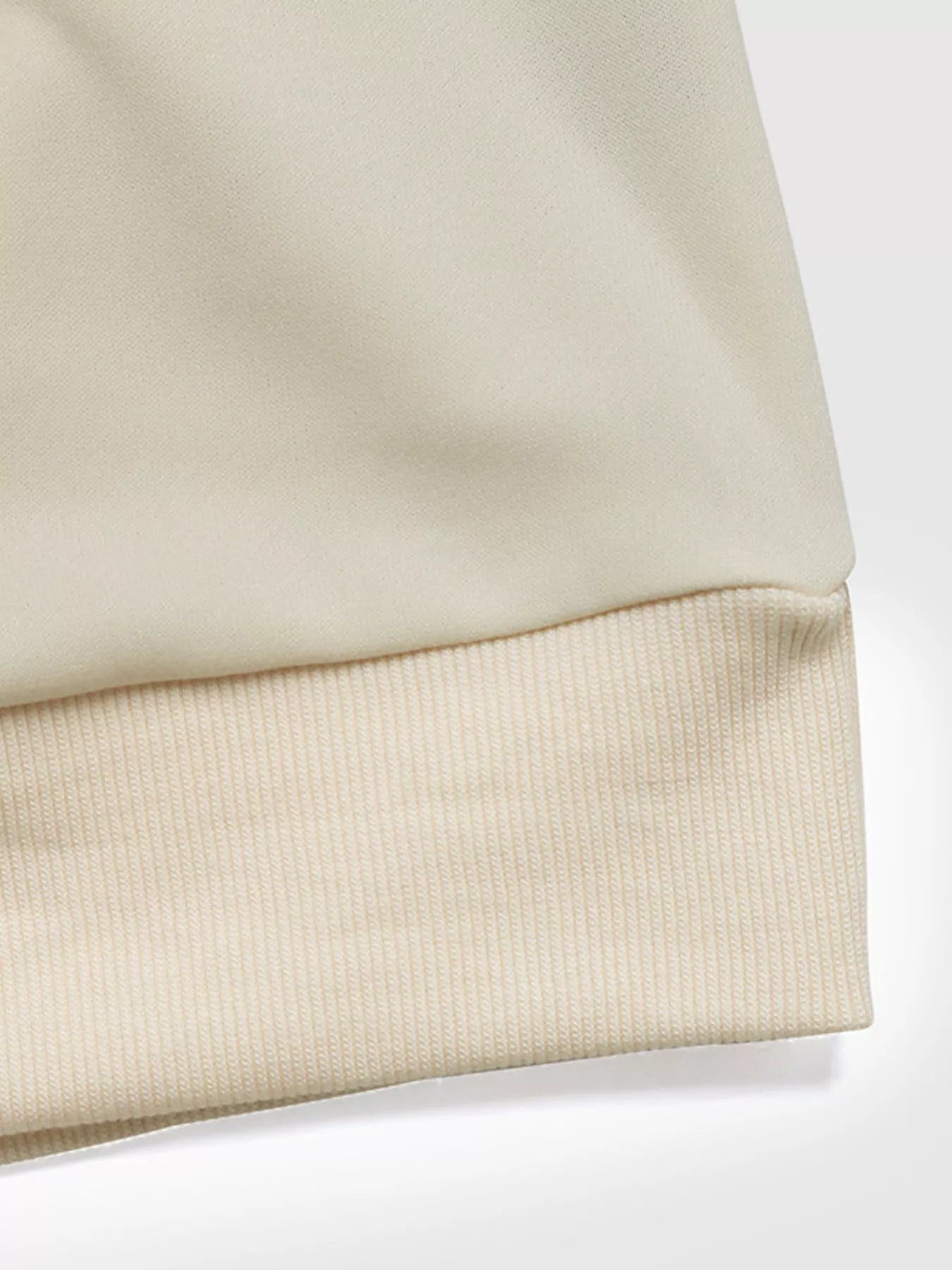 Light gray sweatshirt with bow detail, round neck, and dropped shoulders.
