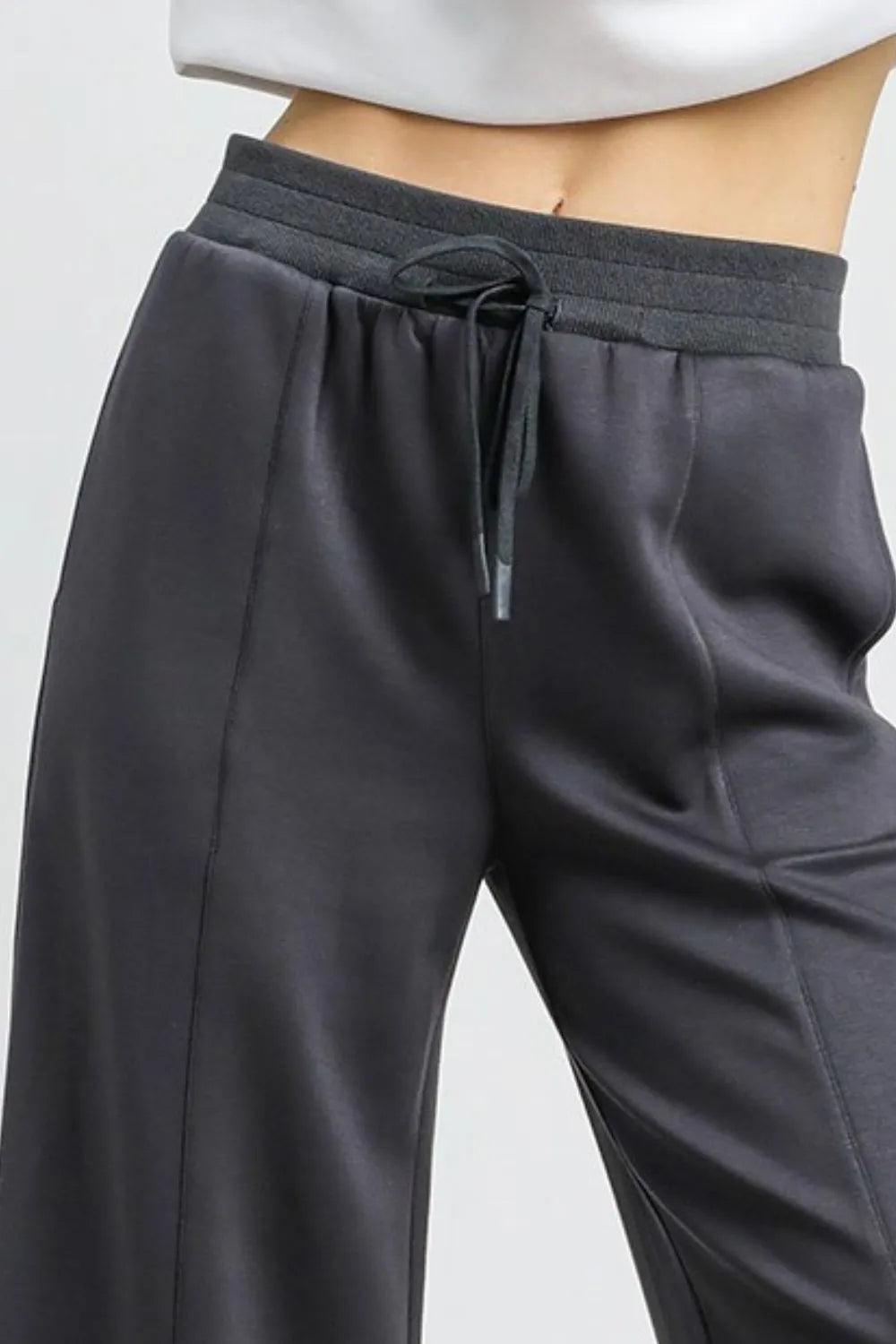 Charcoal gray drawstring wide-leg cropped pants with high waist.